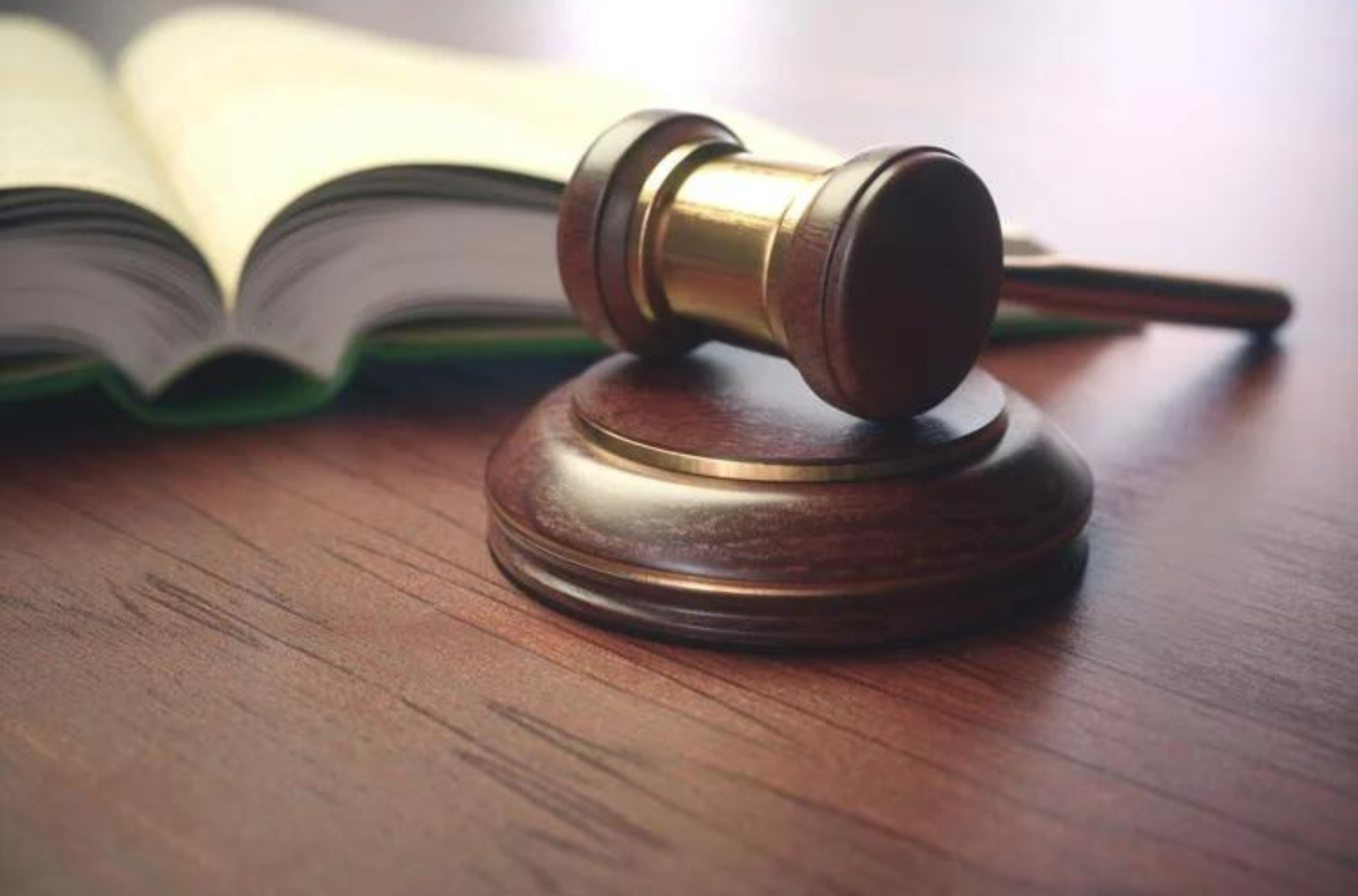 A judge's gavel rests beside a book of law. South Korean media has reported that a man from Guam was sentenced to 20 years in prison in that country for distributing sex abuse videos while he was a resident in Guam. 