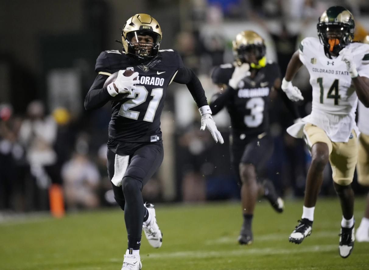 Colorado safety Shilo Sanders, left, runs back an interception for a touchdown as Colorado State wide receiver Tory Horton (14) pursues in the first half of an NCAA football game, Saturday, Sept. 16, 2023 in Boulder, Colo.