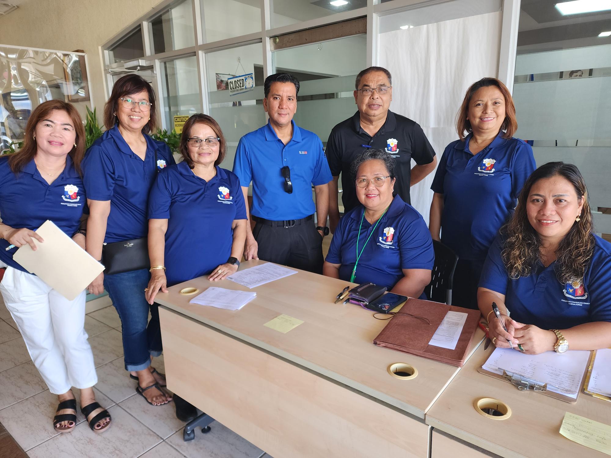 Philippine Consul Joaquin Ricardo Aragon, fourth from left, poses for a photo with Filipino community volunteers during the consular outreach mission to Saipan at Sun Palace Hotel in Susupe  on Saturday.