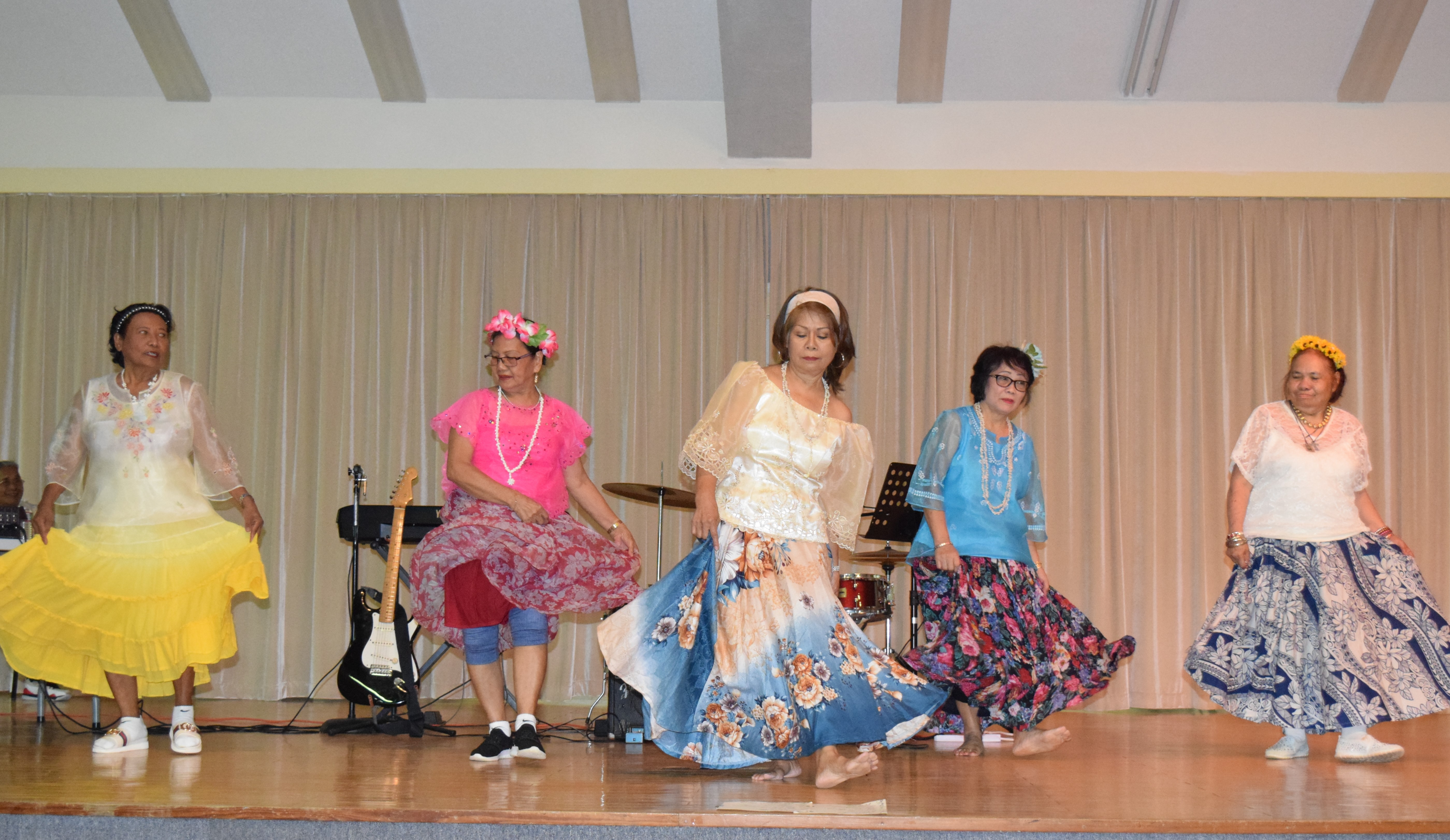 Senior citizens perform a Philippine cultural dance.