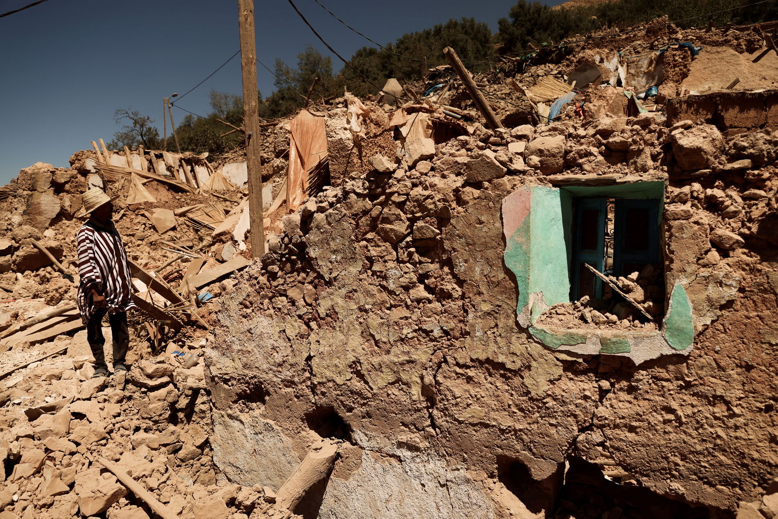 Mohamed Ouchen, 66, a survivor, who helped to pull his sister and her husband with their children from rubble, looks at his destroyed house, in the aftermath of a deadly earthquake, in Tikekhte, near Adassil, Morocco, September 11, 2023. 