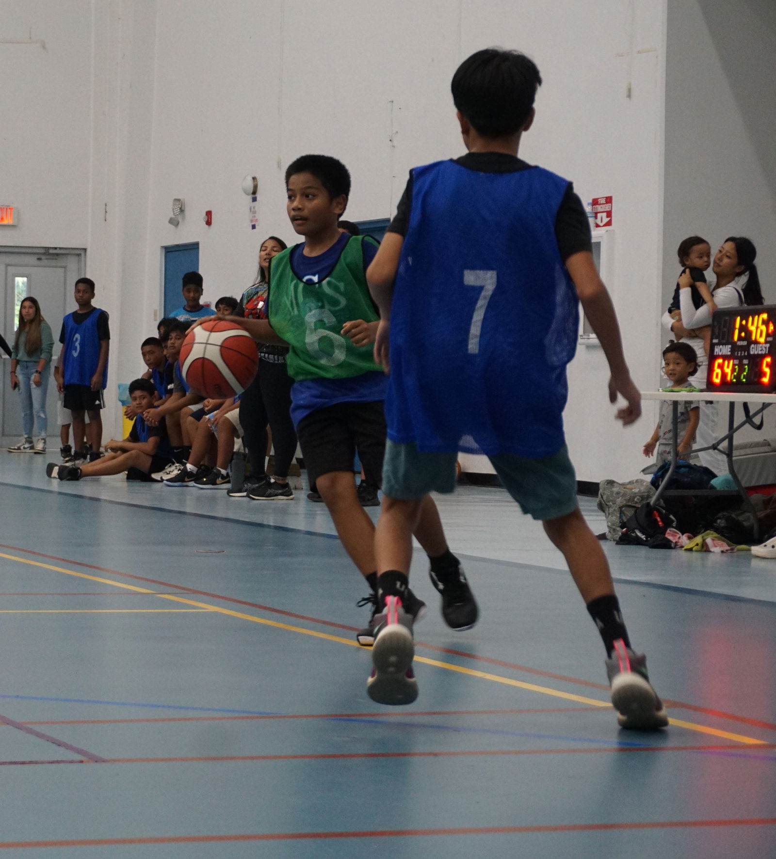 MCS JV's Donald Tagabuel sets up the play during a boys middle school division game of the IT&E Interscholastic Basketball League at the Marianas High School gym.