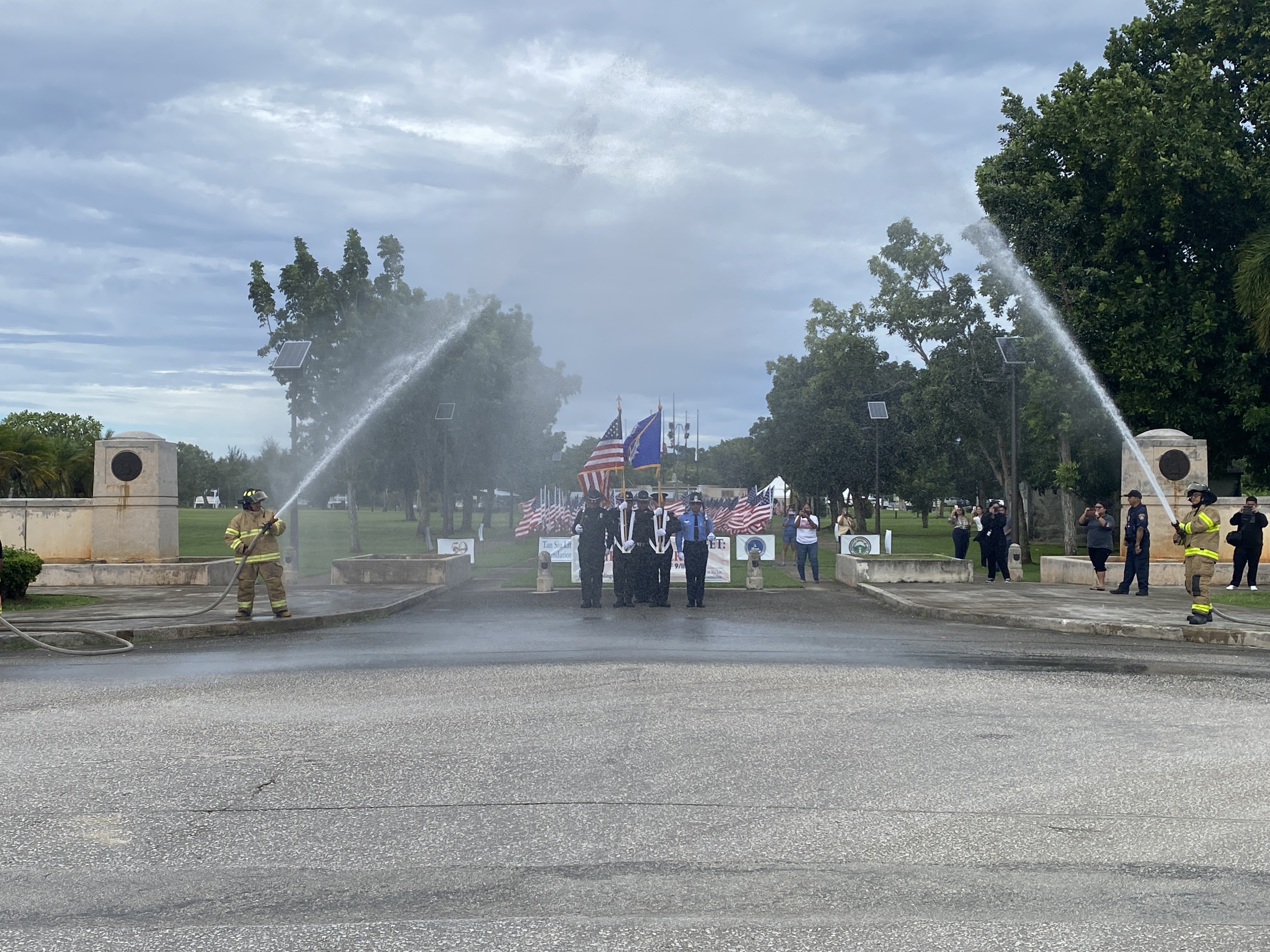 The color guard receives a water hose salute upon arrival at American Memorial Park.