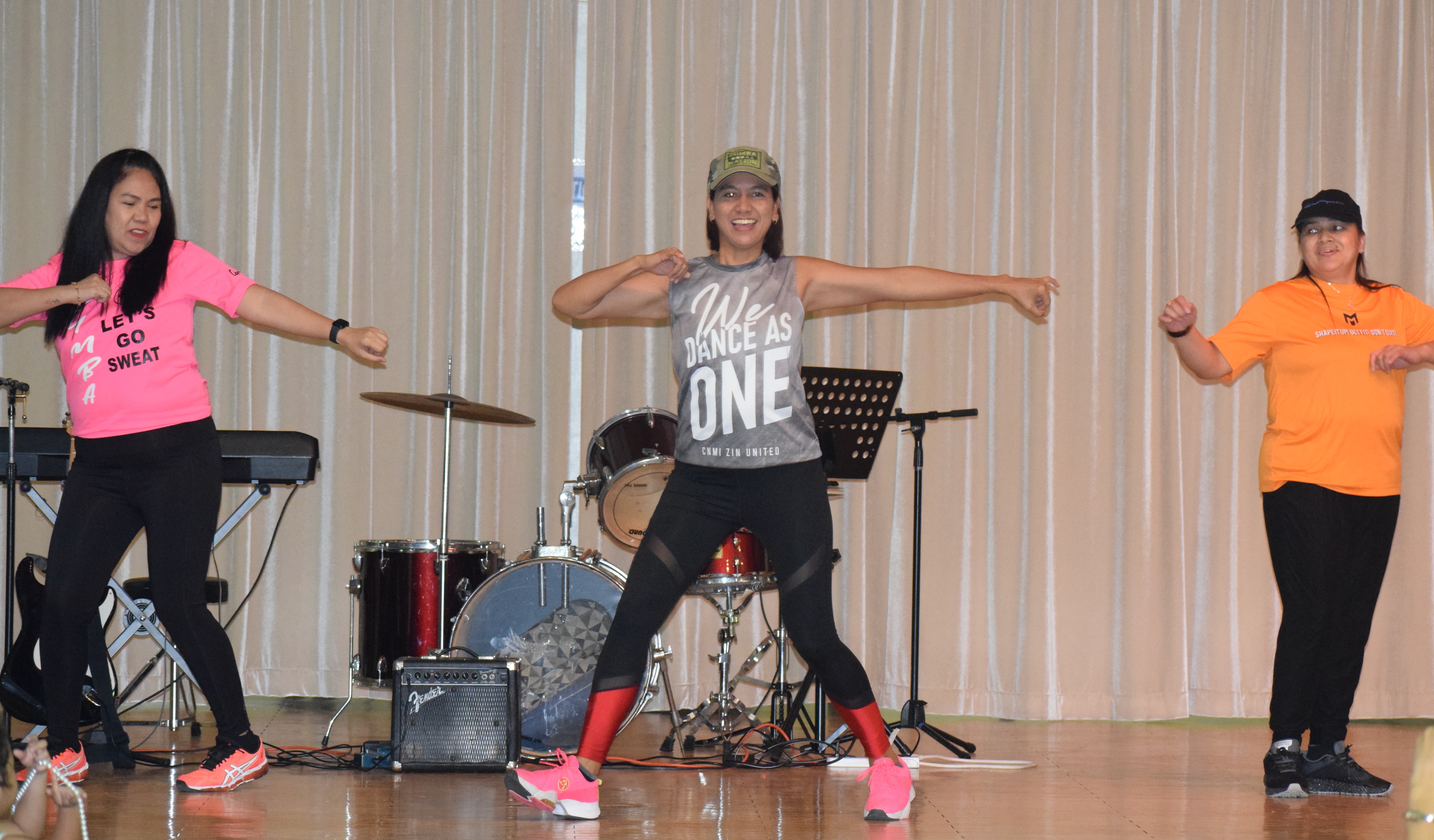 Volunteers Carol Tamporong, Abby Whang and Raquel Ramons perform a dance number.