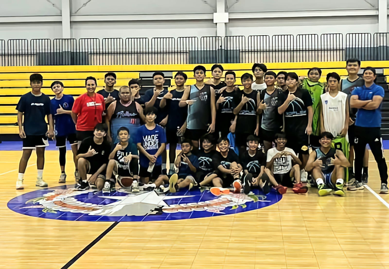 The members of the Rollers and MadFlex basketball clubs pose for a photo with Annie La Fleur, 3rd left, standing, during a referees workshop she conducted on Saturday morning at the Ada gym.
