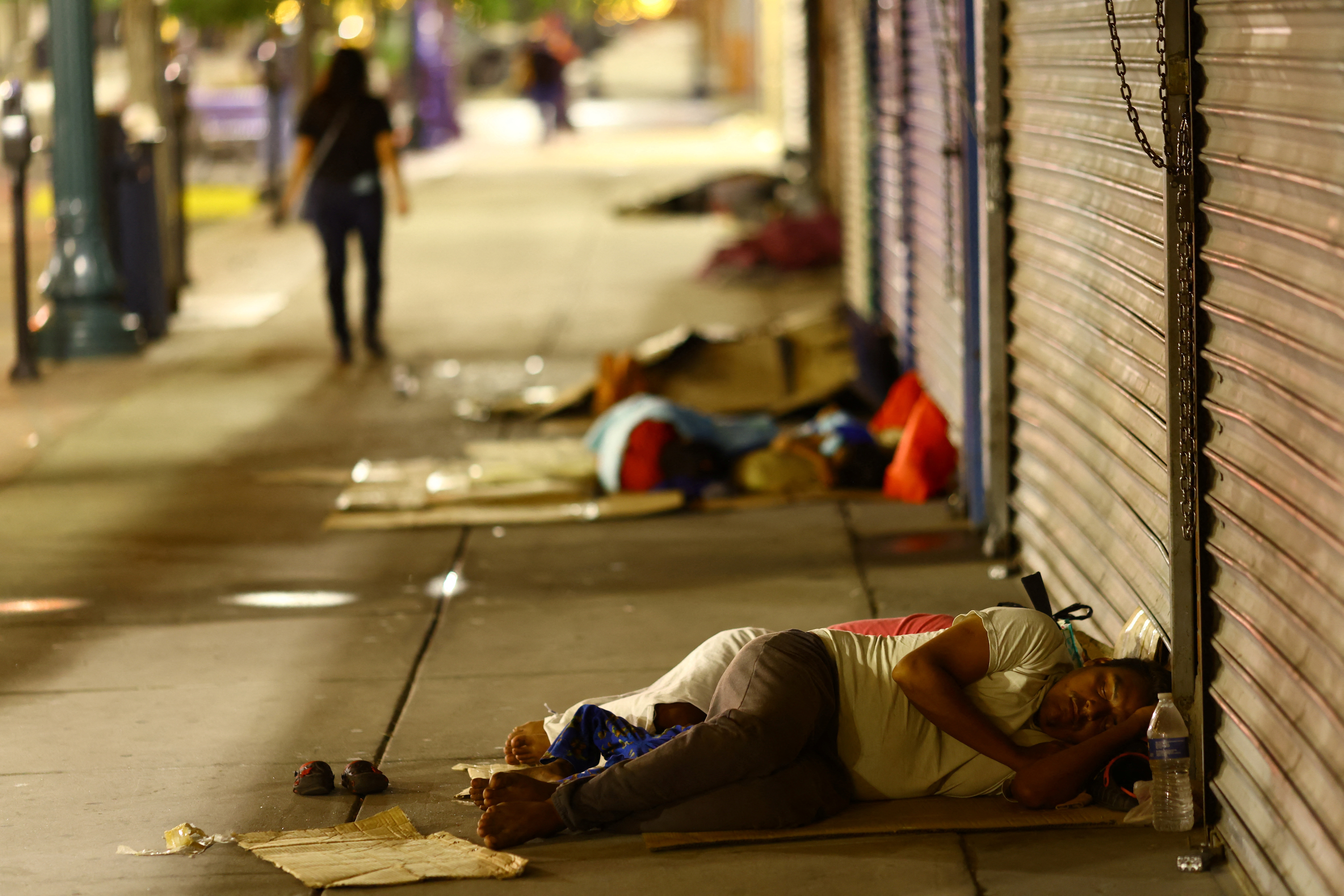 Migrants sleep on the street after being released from U.S. Border Patrol custody in downtown El Paso, Texas, U.S., September 12, 2023.