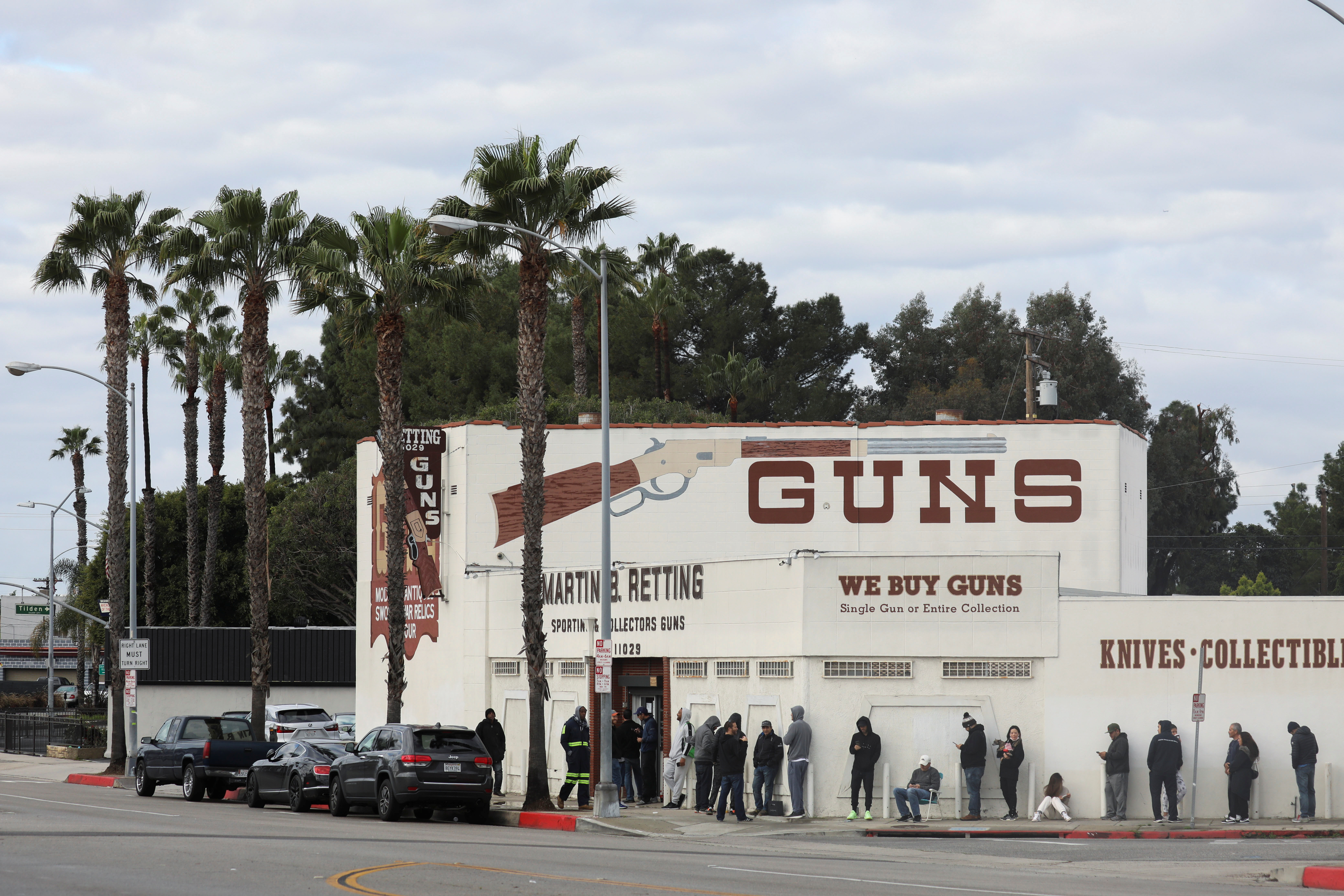 People wait in line outside to buy supplies at the Martin B. Retting, Inc. gun store amid fears of the global growth of coronavirus cases, in Culver City, California, U.S. March 15, 2020. 