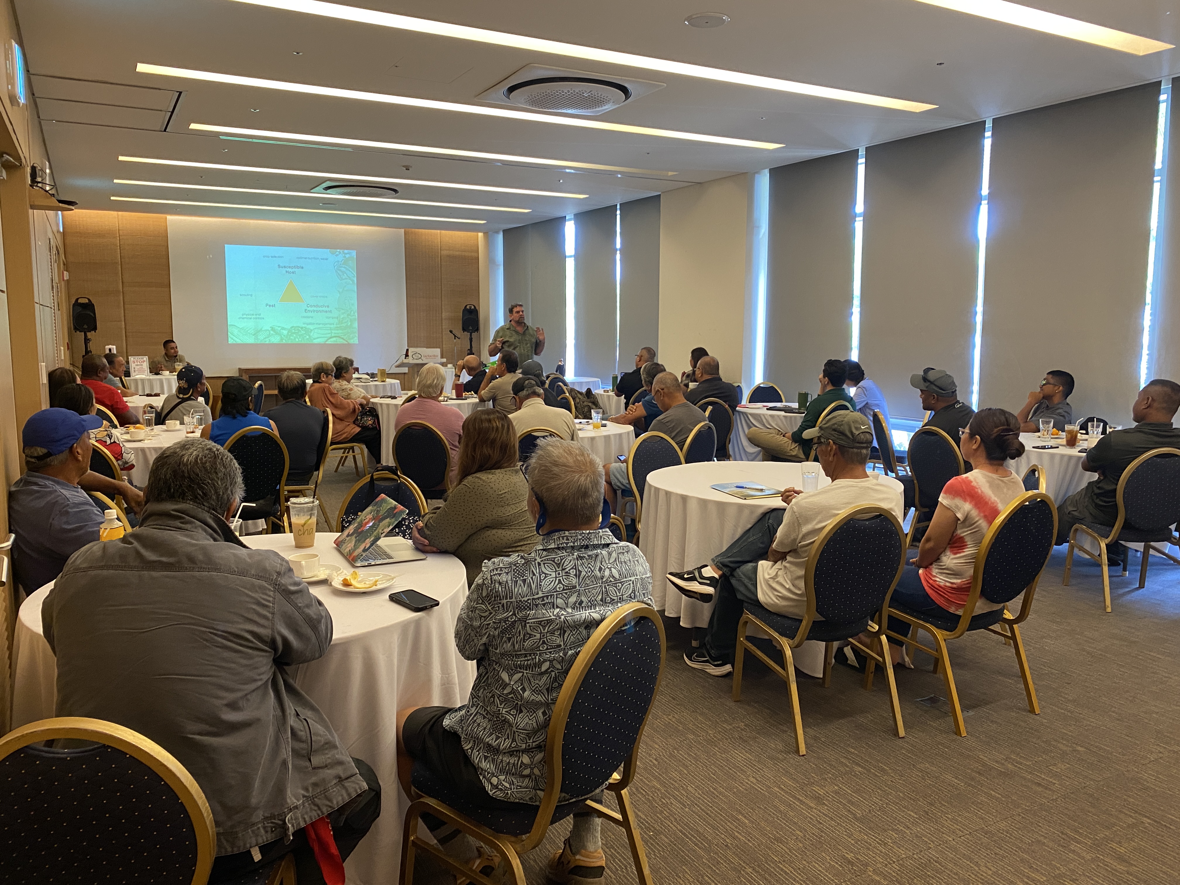 Dr. Theodore Radovich, an agricultural researcher, talks about organic farming with local farmers at the LaoLao Bay Golf & Resort on Monday, Sept. 25.