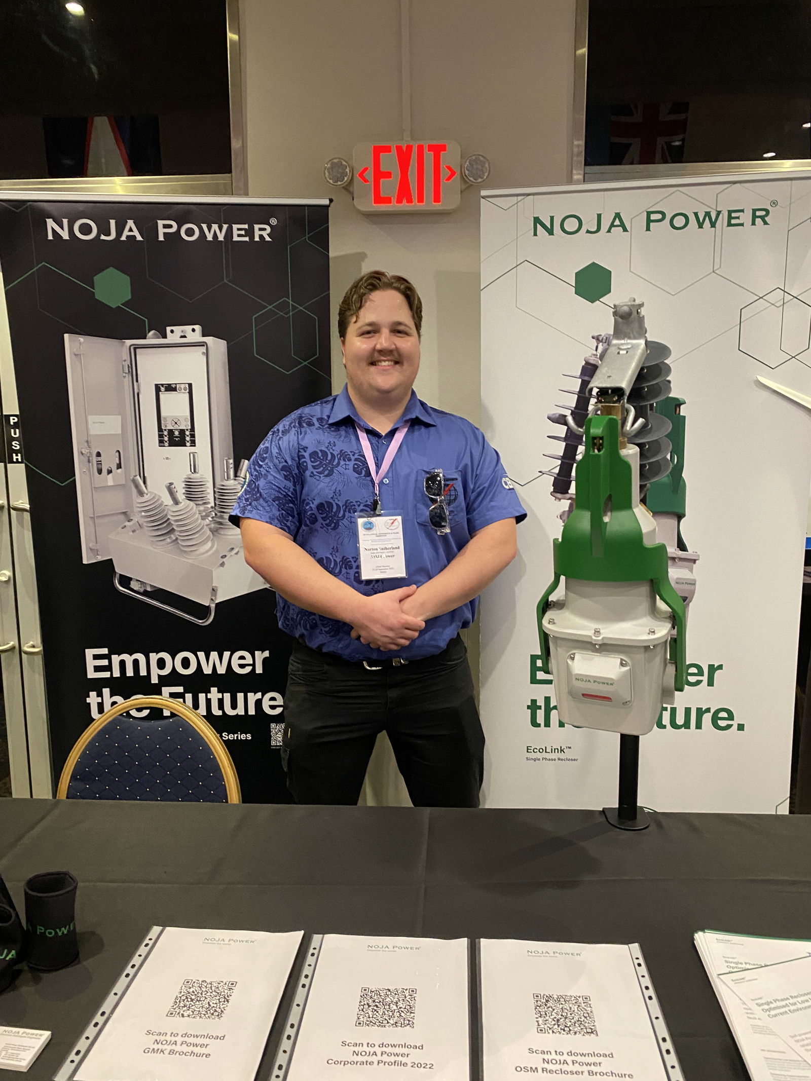 Norton Sutherland of NOJA Power stands next to a NOJA Power EcoLink.