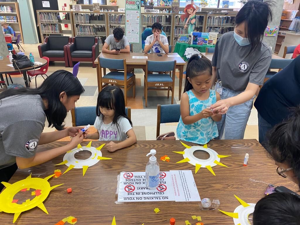 Children participate in an arts and crafts activity at JKPL.