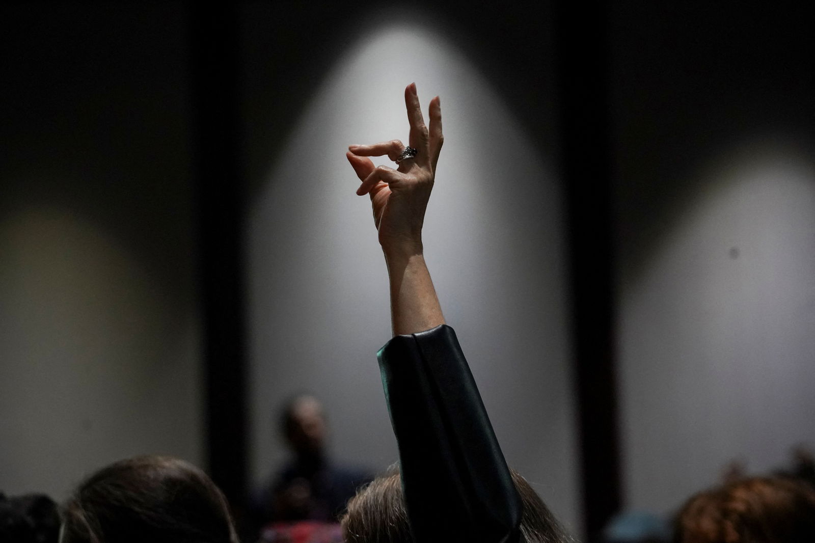 A person snaps to show support as community members speak during the city council meeting to protest against the controversial "Cop City" project, inside the city hall in Atlanta, Georgia, U.S., May 15, 2023. REUTERS/Megan Varner/ File Photo