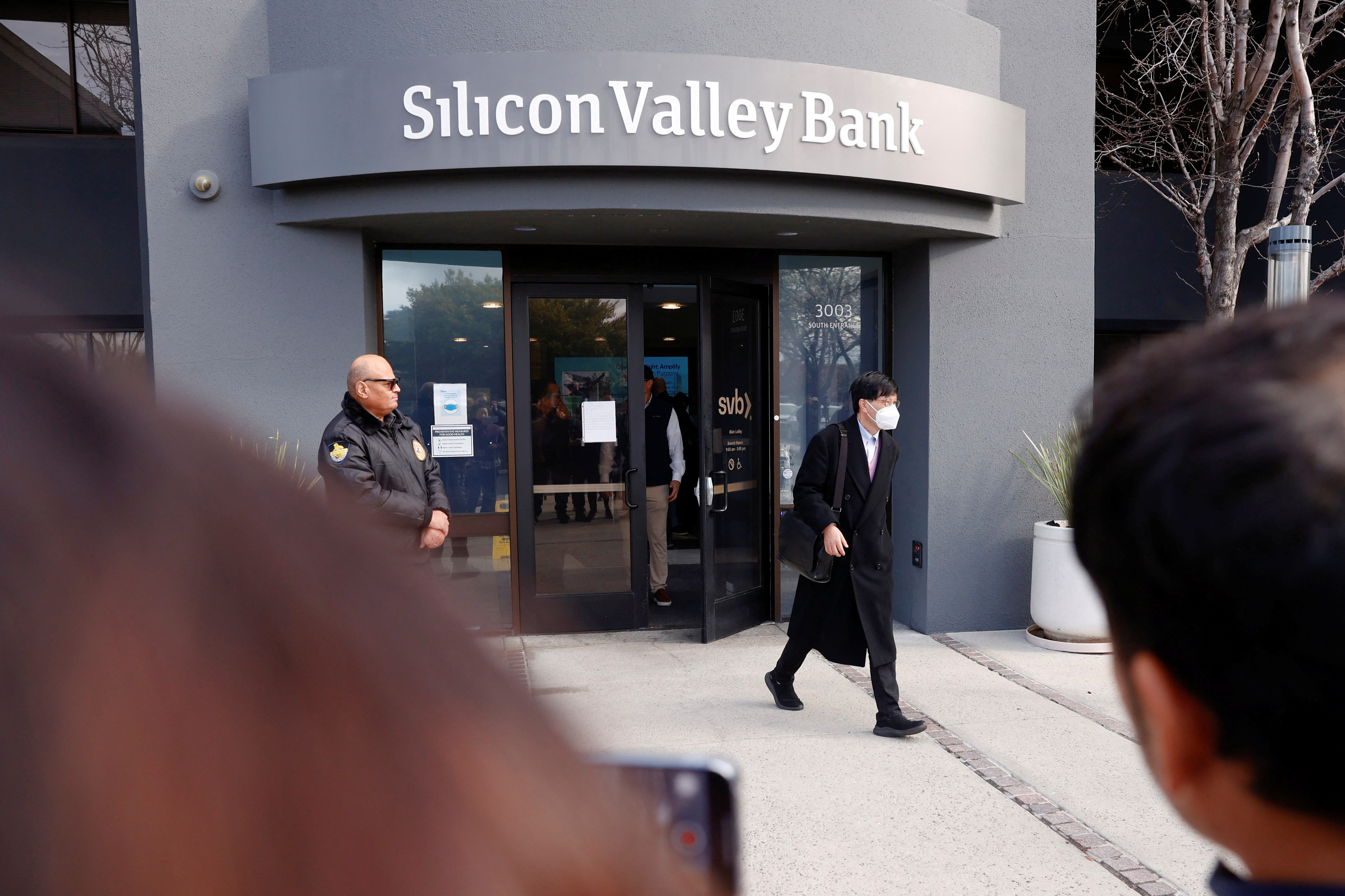 A customer leaves after speaking with FDIC representatives inside of the Silicon Valley Bank headquarters in Santa Clara, California, U.S., March 13, 2023. 