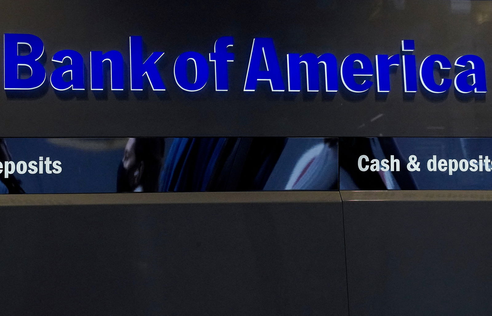 A person walks past a Bank of America sign in the Manhattan borough of New York City, New York, U.S., January 19, 2022. 