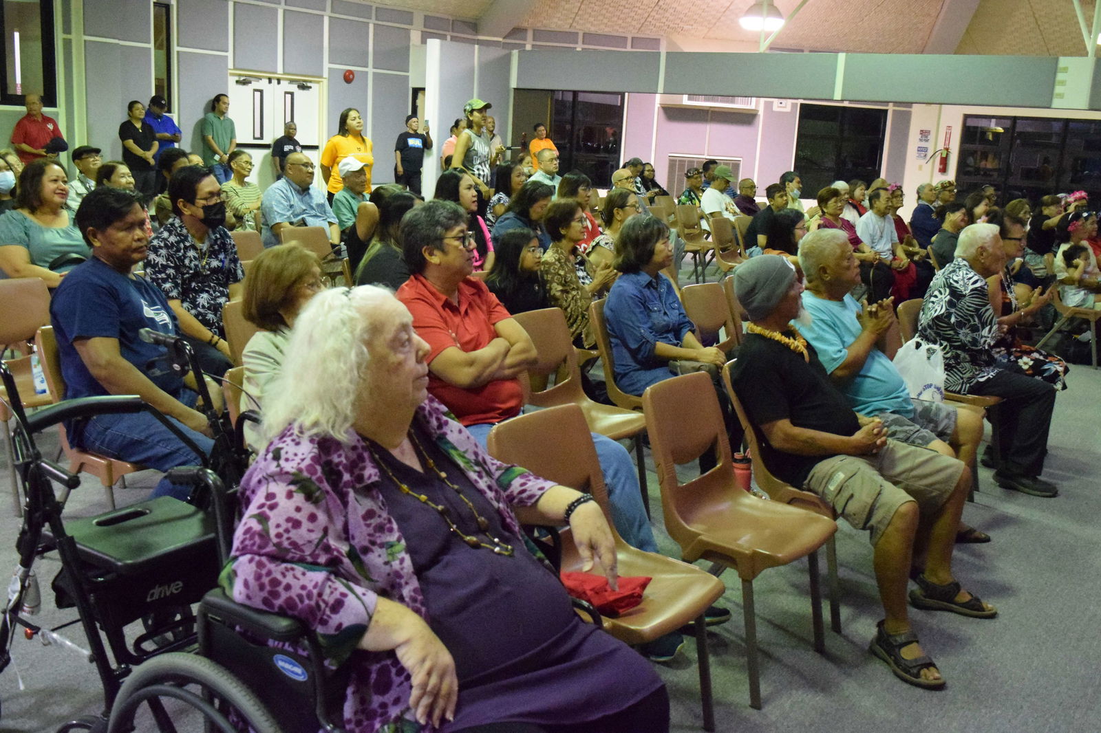 Members of the audience watch the senior citizens showcase their talents.