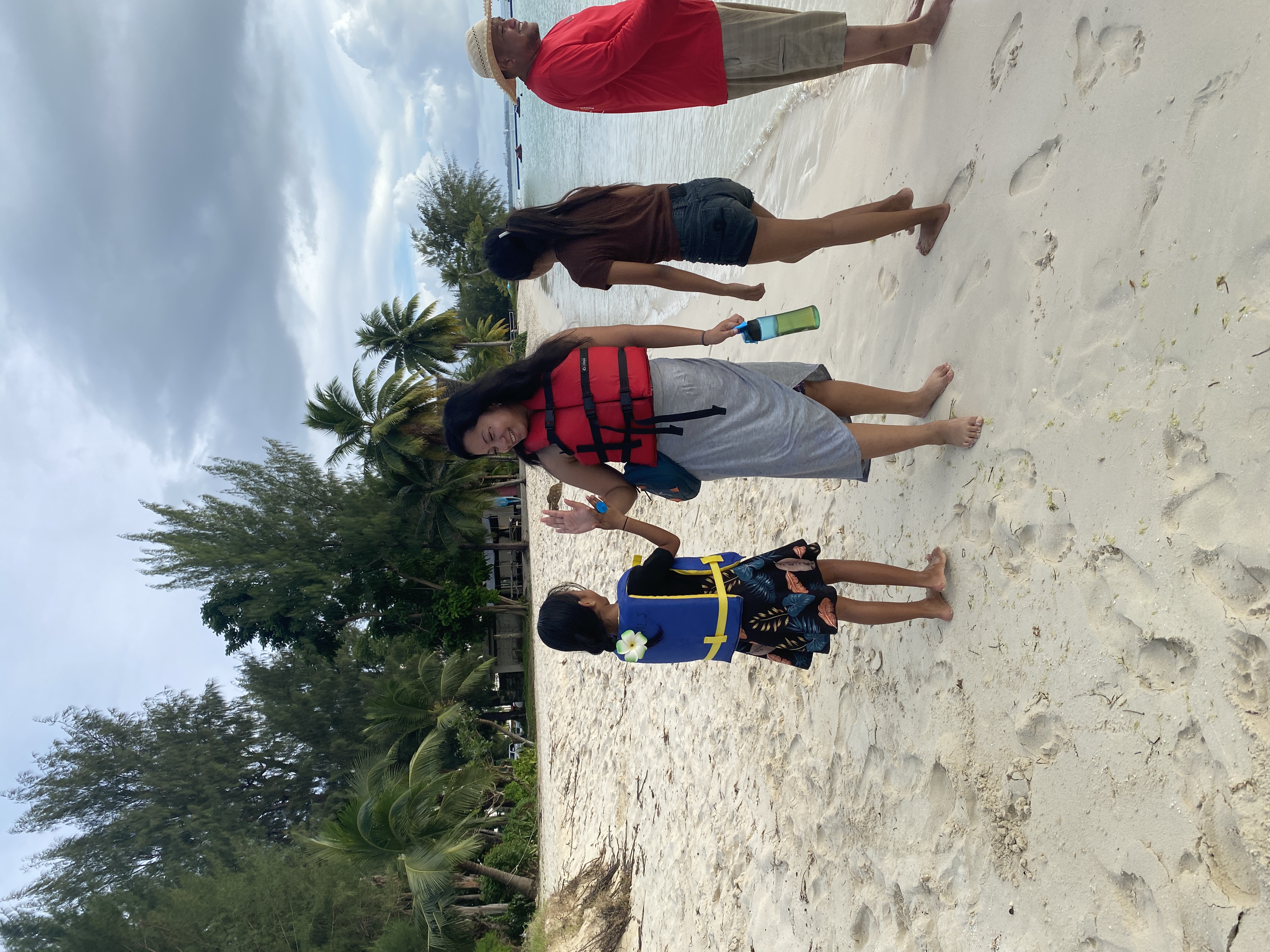 Anaya Tudela, left, high fives her cousin Nasima Uddin, after their sail on the Saipan Lagoon.