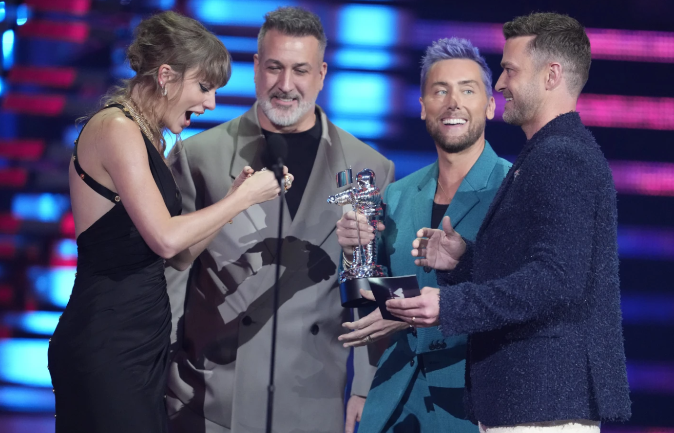 Joey Fatone, from center, Lance Bass, and Justin Timberlake of NSYNC present the award for best pop to Taylor Swift, far left, for "Anti-Hero" during the MTV Video Music Awards on Tuesday, Sept. 12, 2023, at the Prudential Center in Newark, N.J.