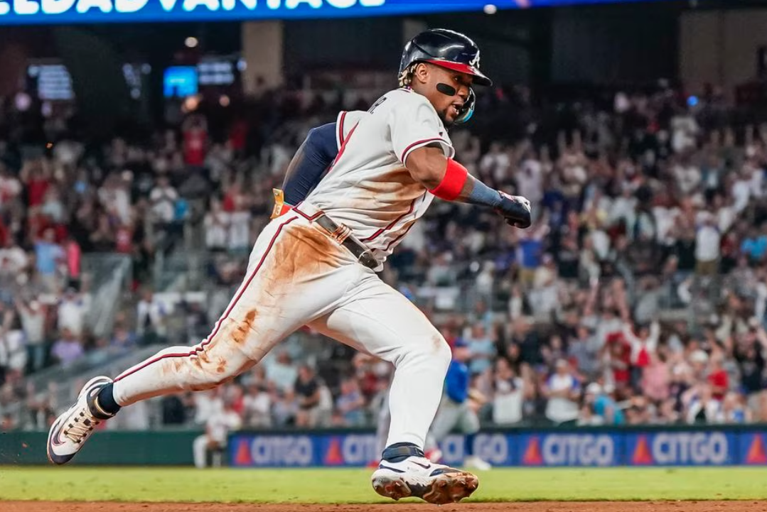 Atlanta Braves right fielder Ronald Acuna Jr. (13) rounds third base on his way to scoring a run against the Chicago Cubs during the eighth inning at Truist Park in Cumberland, Georgia, Sept. 27, 2023.