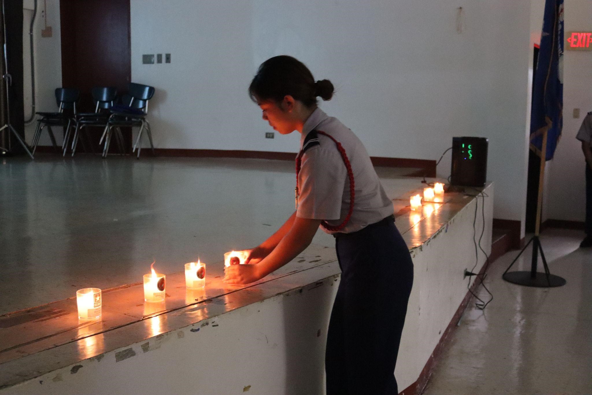 C/CPL Isa Dosalua places down one of the 13 candles.