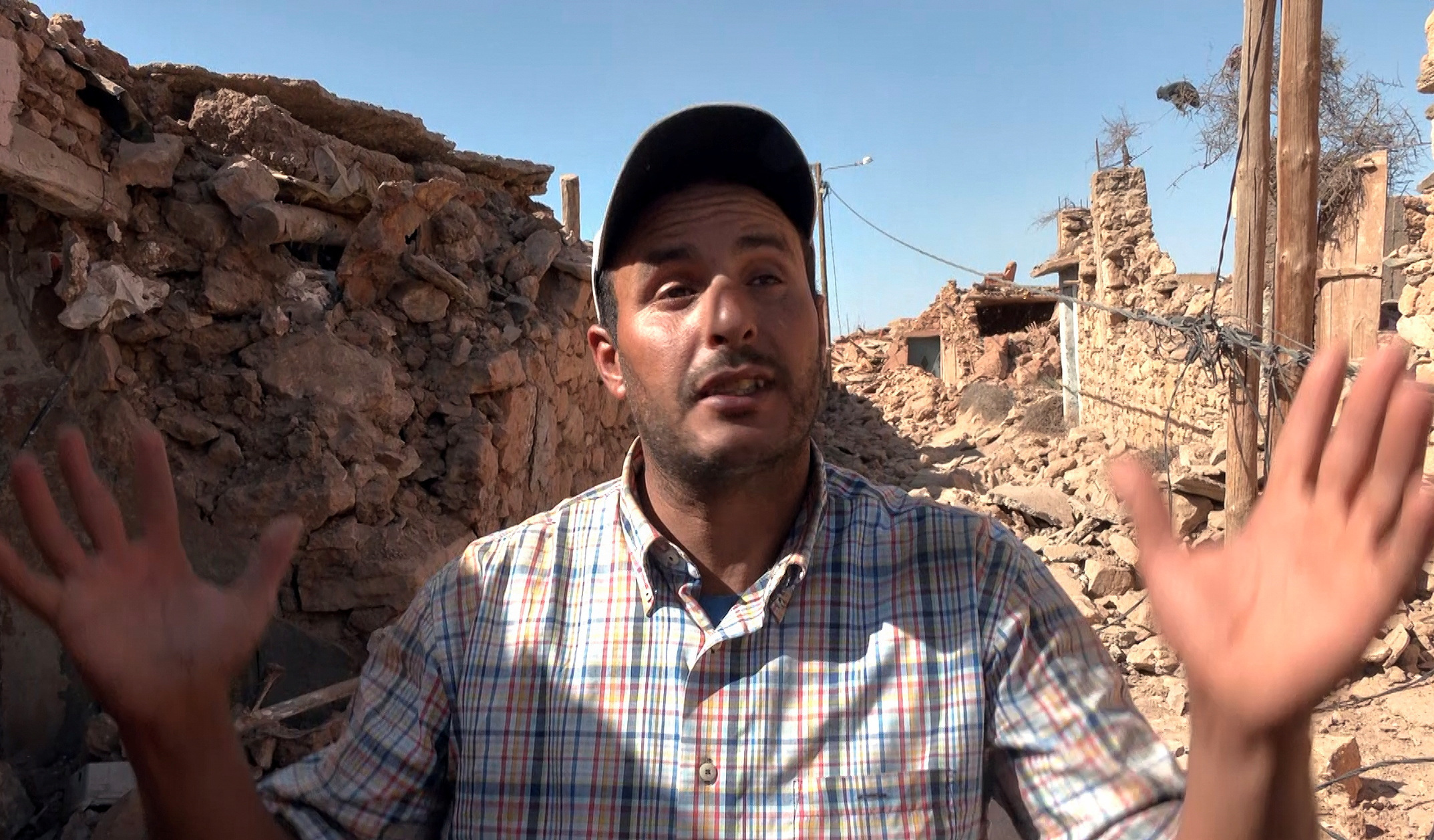 Hamid ben Henna, who lost his son Marouane in the powerful earthquake, gestures during an interview with Reuters, in Tafeghaghte, a remote village of the High Atlas mountains, following a powerful earthquake in Morocco, September 10, 2023, in this still image taken from a video. REUTERS TV/via REUTERS