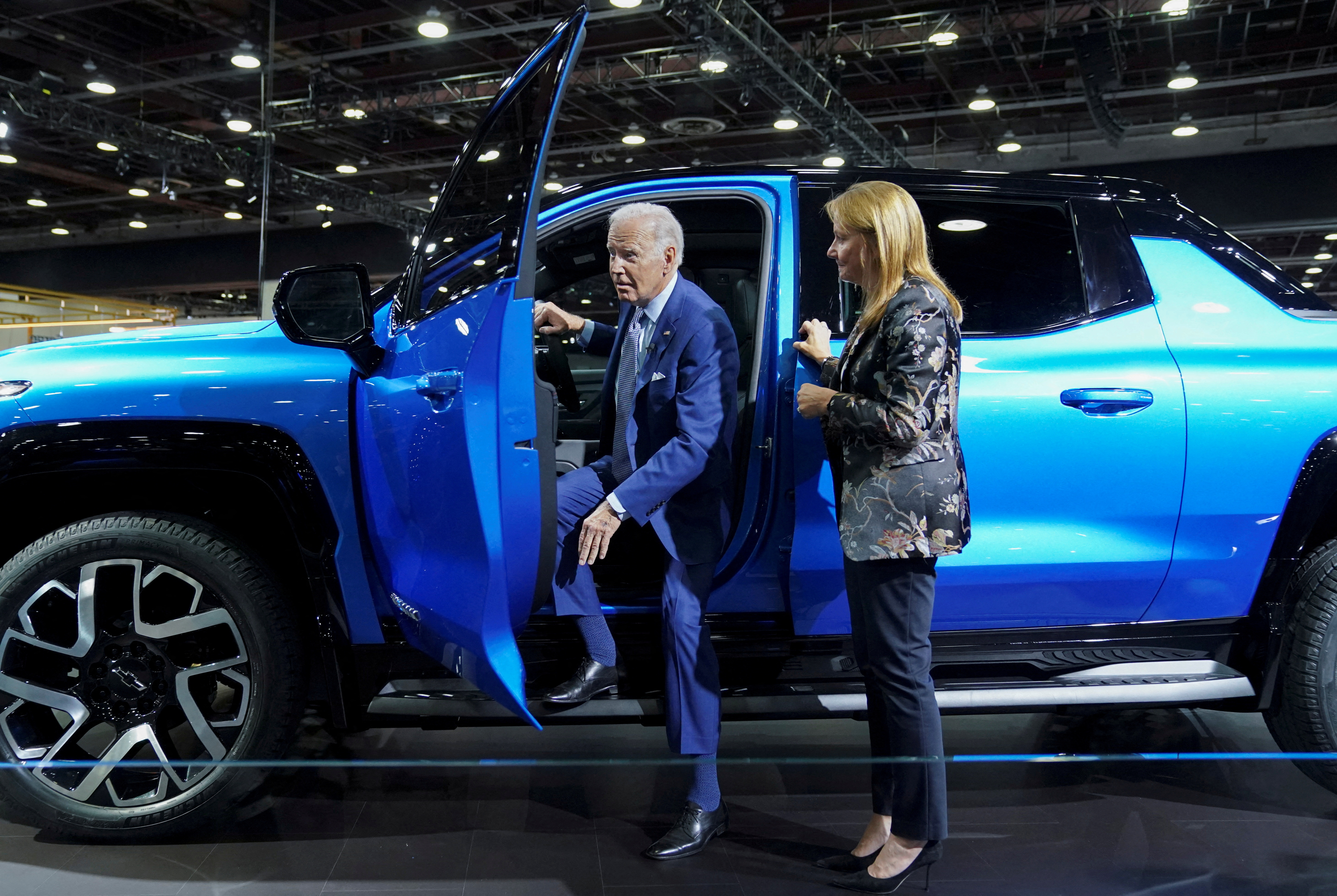 U.S. President Joe Biden steps out of an electric Chevrolet Silverado EV pickup truck being shown to him by General Motors Chief Executive Mary Barra during a visit to the Detroit Auto Show to highlight electric vehicle manufacturing in America, in Detroit, Michigan, U.S., September 14, 2022. 