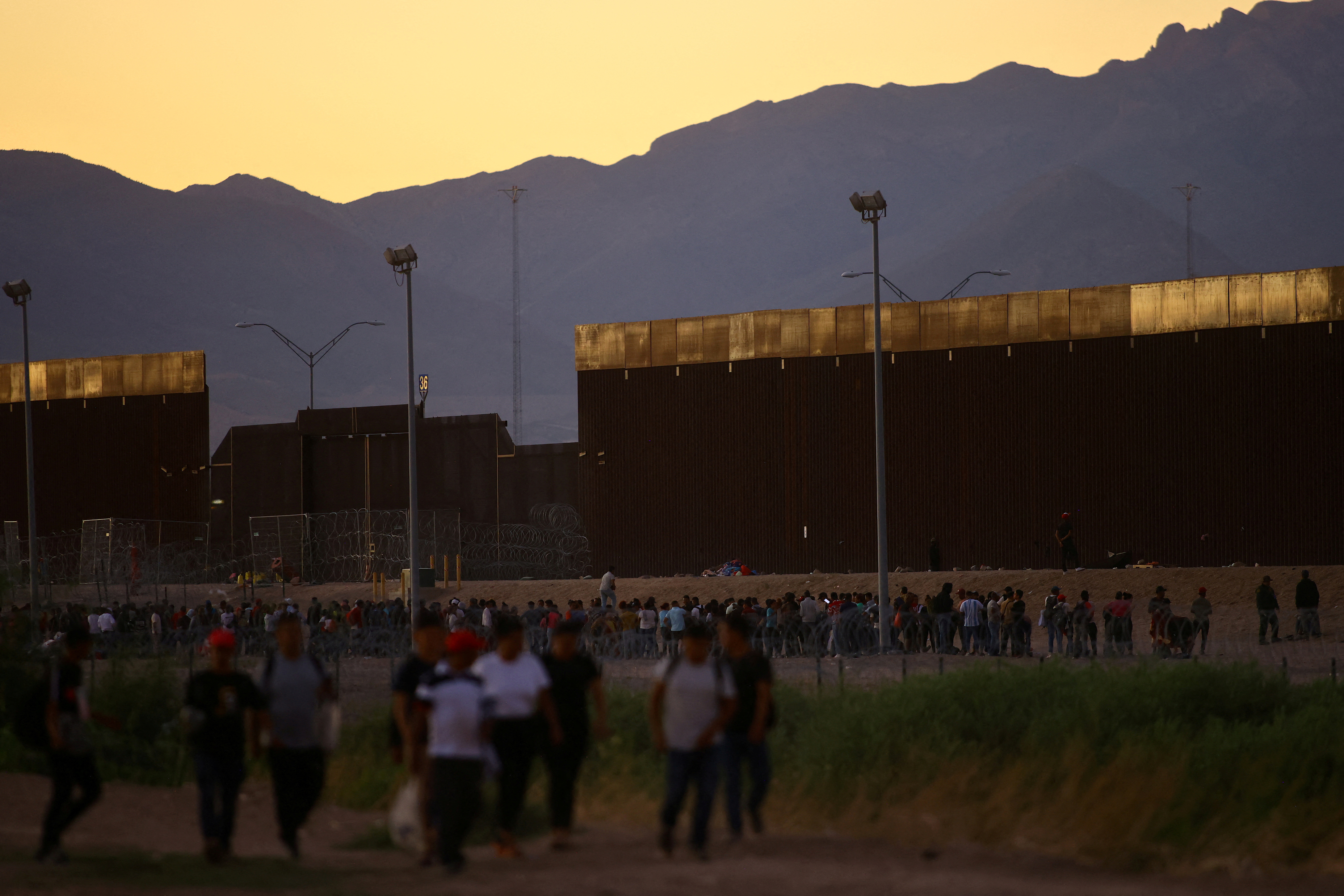 Migrants seeking asylum in the United States gather near a border wall on the banks of the Rio Bravo River, on the border between the U.S. and Mexico, as seen from Ciudad Juarez, Mexico September 19, 2023. 