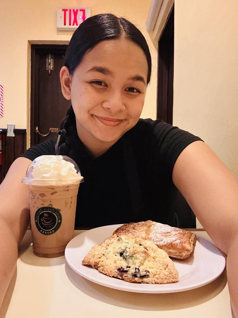 Ava Deleon Guerrero smiles with her perfect coffee and pastry pair.