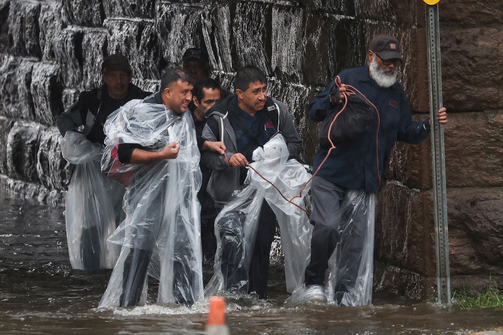 Residents escape rising floodwaters during a heavy rain storm in the New York City suburb of Mamaroneck in Westchester County, New York, U.S., September 29, 2023. 