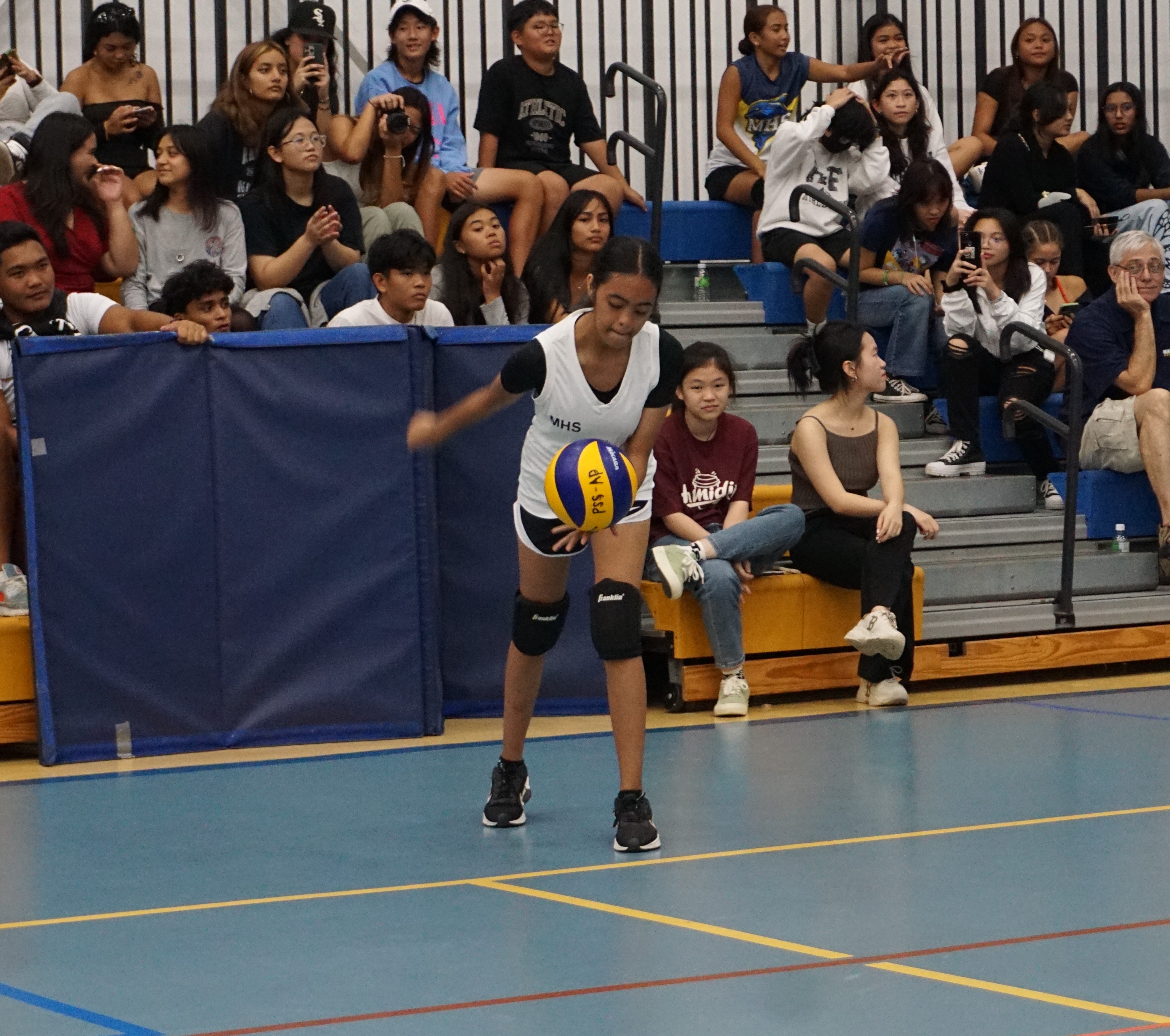 A Marianas High School II player attempts the underhand serve during a girls high school division game of the NMIVA-PSS Interscholastic Volleyball League SY23-24 at the MHS gym.