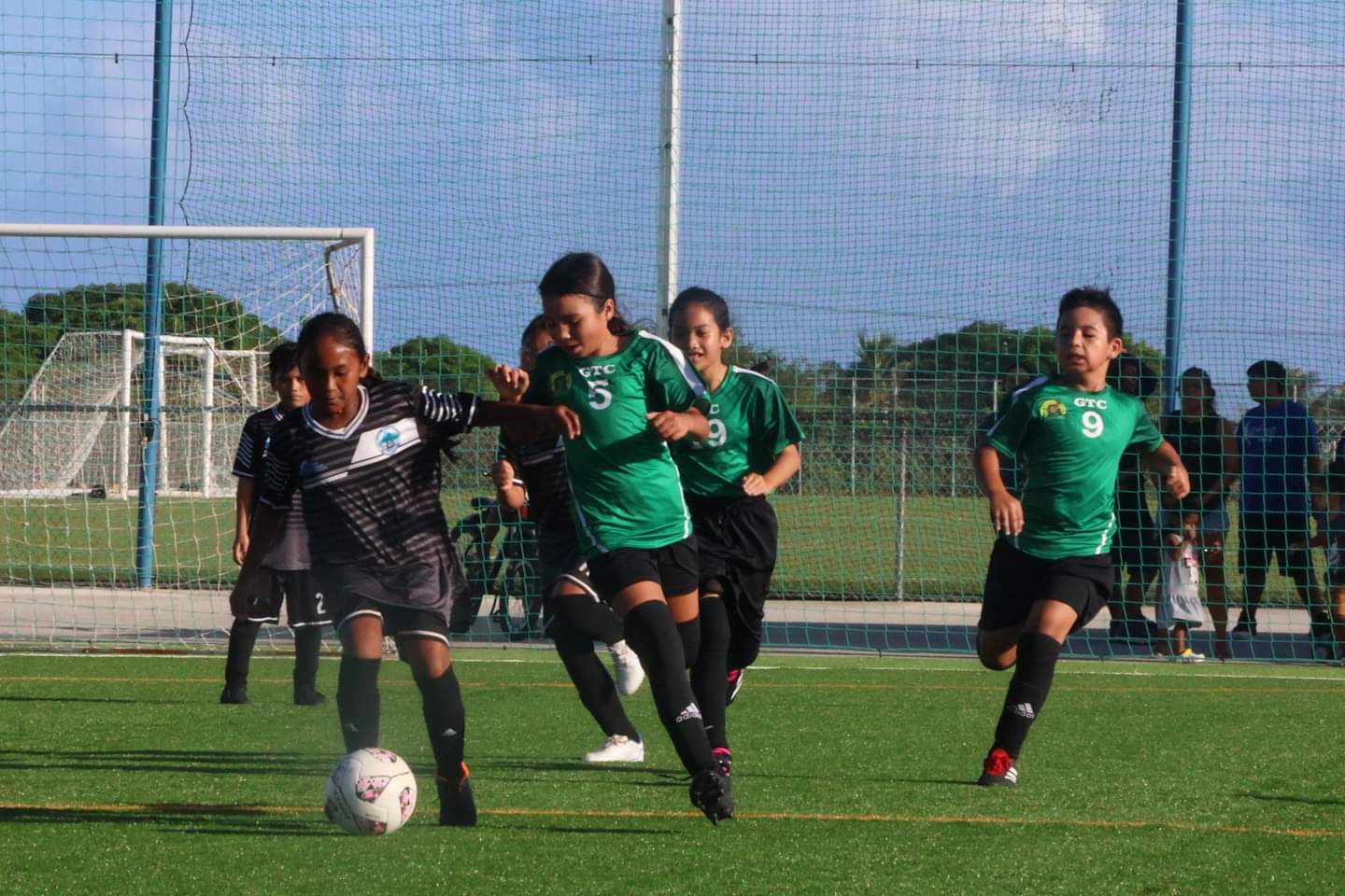 Garapan Elementary School's Athitaya Saukan dribbles forward as Gregorio T. Camacho Elementary School's Gianna Moses closes in during an elementary division game of the NMIFA-PSS Interscholastic Soccer League SY23-24 on Wednesday at NMI Soccer Training Center  in Koblerville.