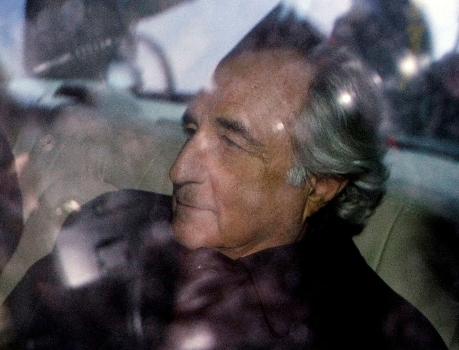 Bernard Madoff is escorted in a vehicle from Federal Court in New York January 5, 2009. 