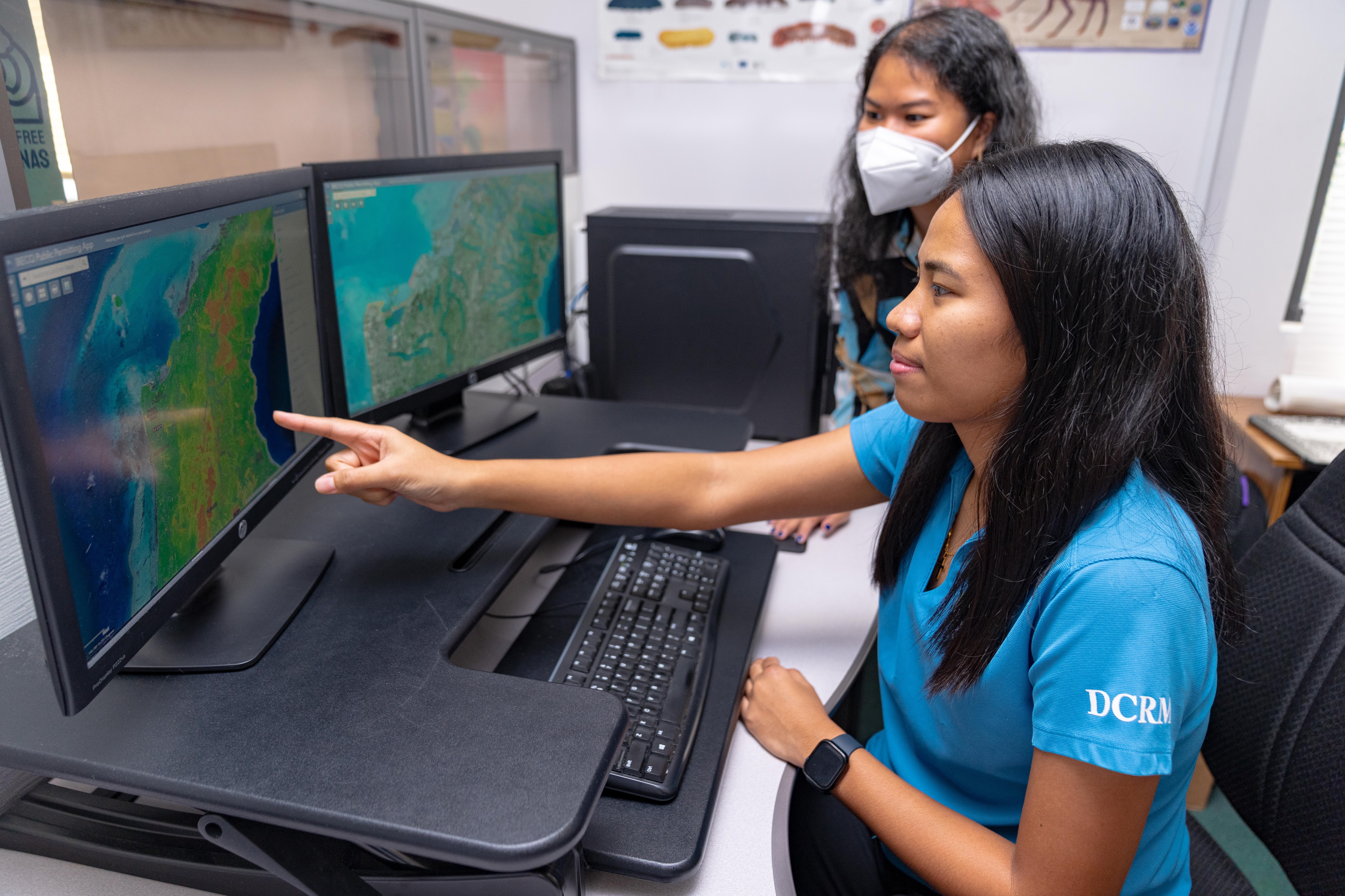 DCRM GIS Specialist Dianne Pablo and her colleague, DCRM Coastal Planner Mary Urena, discuss the BECQ Public Permitting App, an essential tool for informing development decisions in the CNMI.