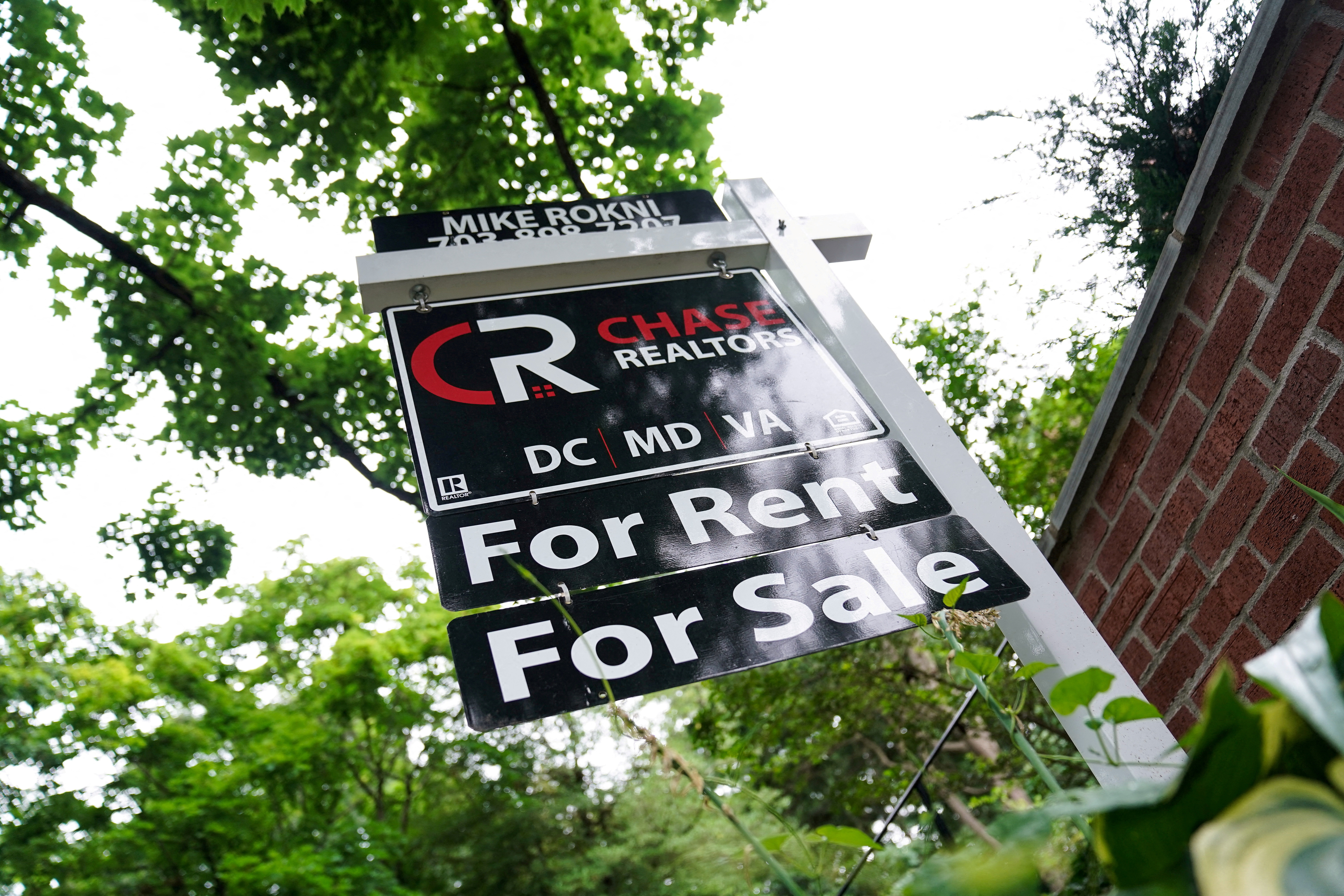 A "For Rent, For Sale" sign is seen outside of a home in Washington, U.S., July 7, 2022. REUTERS/Sarah Silbiger/File Photo