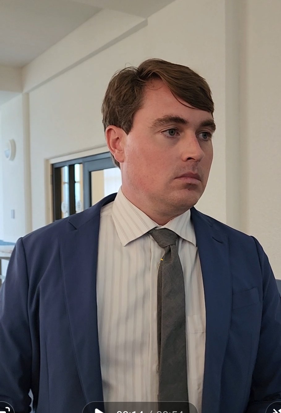 Assistant Attorney General James Robert Kingman talks to reporters after a hearing on Monday morning.