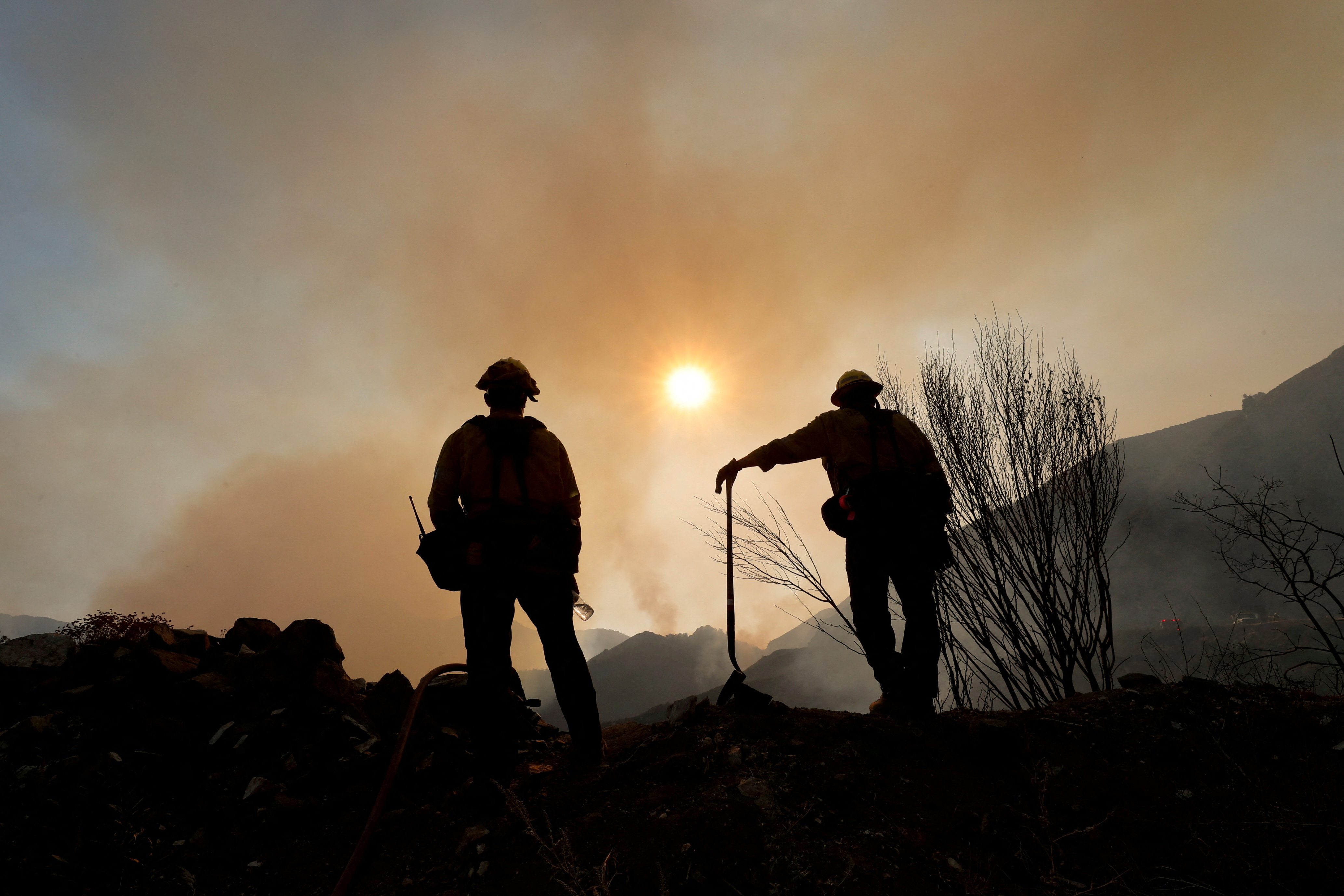 Firefighters work at the site of the Bobcat Fire burning near Mount Wilson in the Angeles National Forest, near Los Angeles, U.S., September 23, 2020. REUTERS/Mario Anzuoni/File Photo