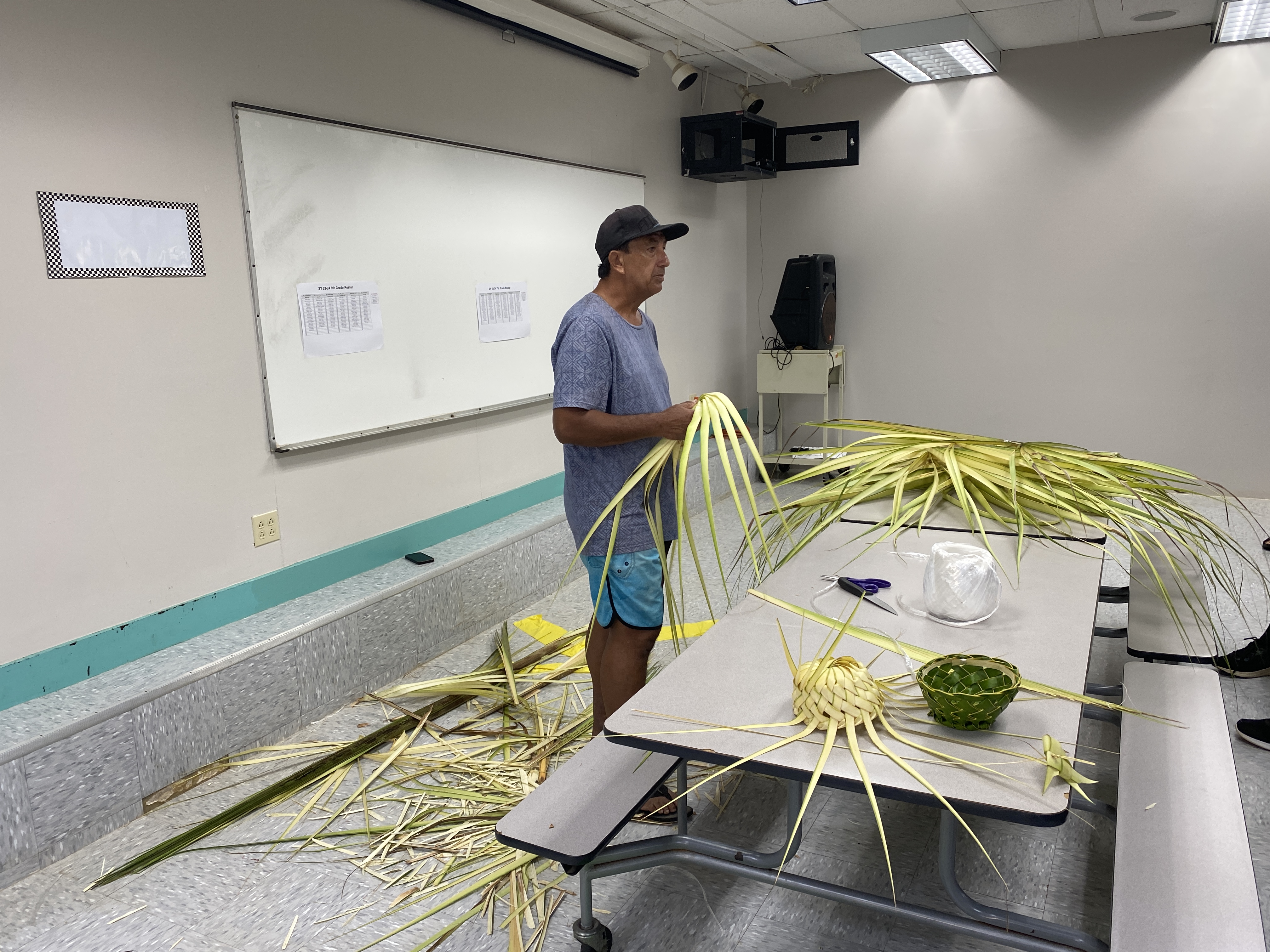 Jacob Teuira demonstrates weaving at Dandan Middle School.