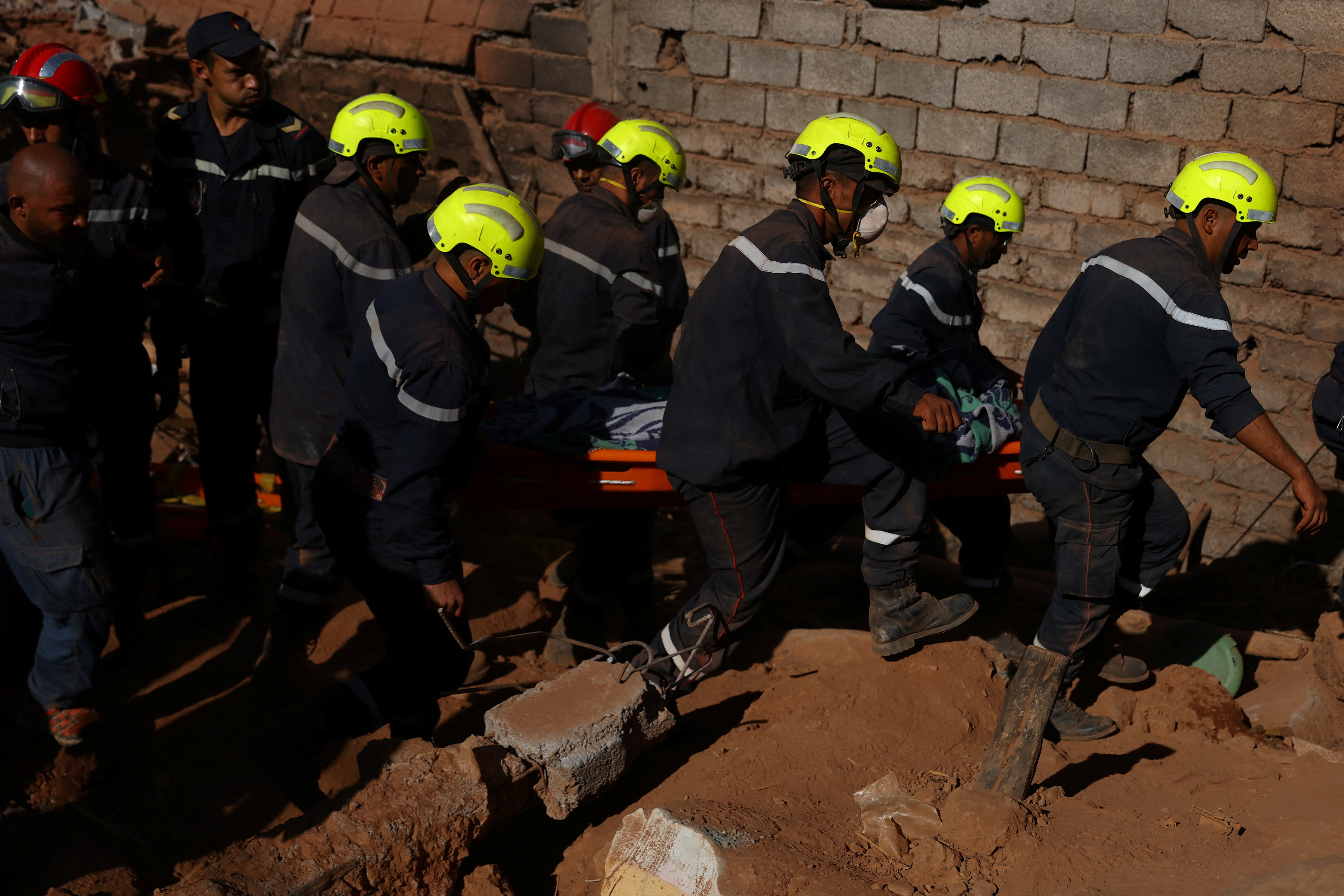 Rescue workers recover one body from the rubble, in the aftermath of a deadly earthquake in Ouirgane, Morocco, September 10, 2023. REUTERS/Hannah McKay