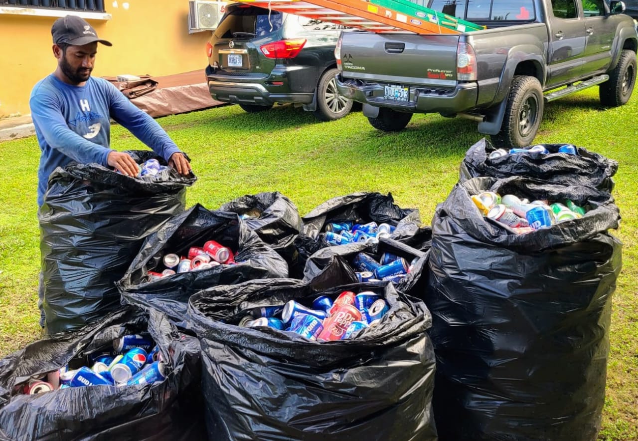 An Office of Grant Management and State Clearinghouse employee gathers aluminum cans on Rota.