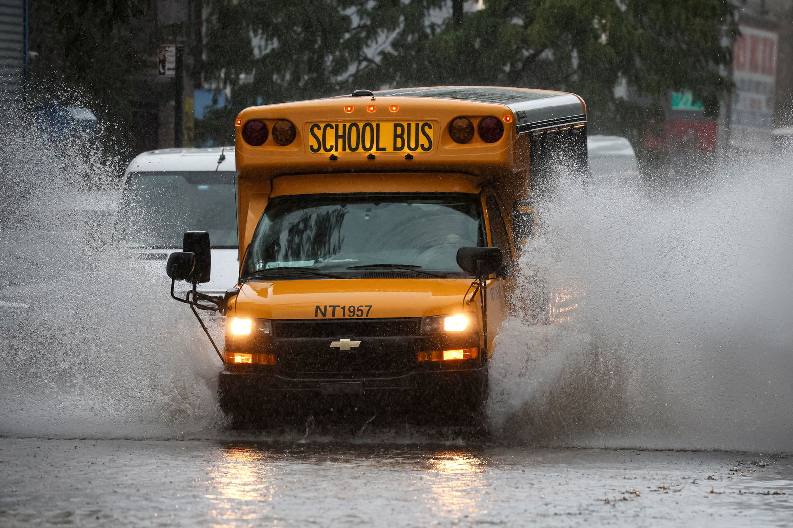 A school bus drives on a flooded street, as the remnants of Tropical Storm Ophelia bring flooding across mid-Atlantic and Northeast, in the Brooklyn borough of New York City, U.S., September 29, 2023. 