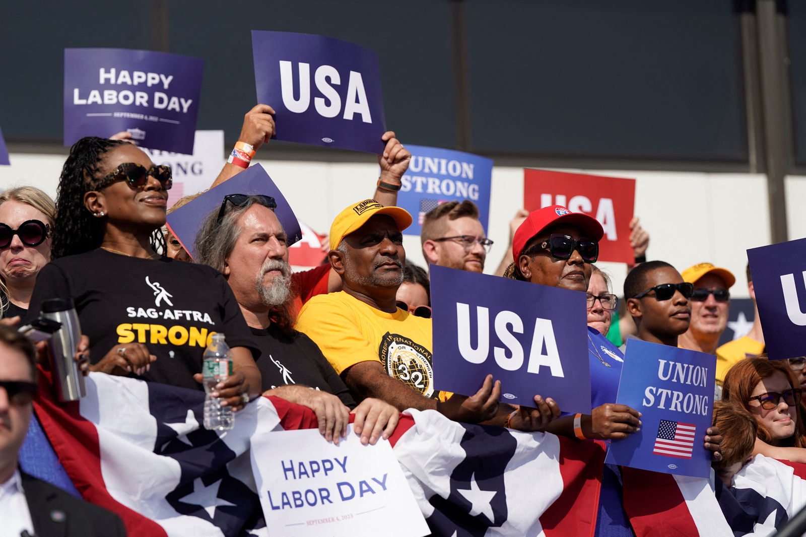 People watch as U.S. President Joe Biden delivers remarks celebrating Labor Day and honoring America’s workers and unions at the Annual Tri-State Labor Day Parade at Sheet Metal Workers' Local Union 19, in Philadelphia, Pennsylvania, U.S., September 4, 2023. REUTERS/Joshua Roberts