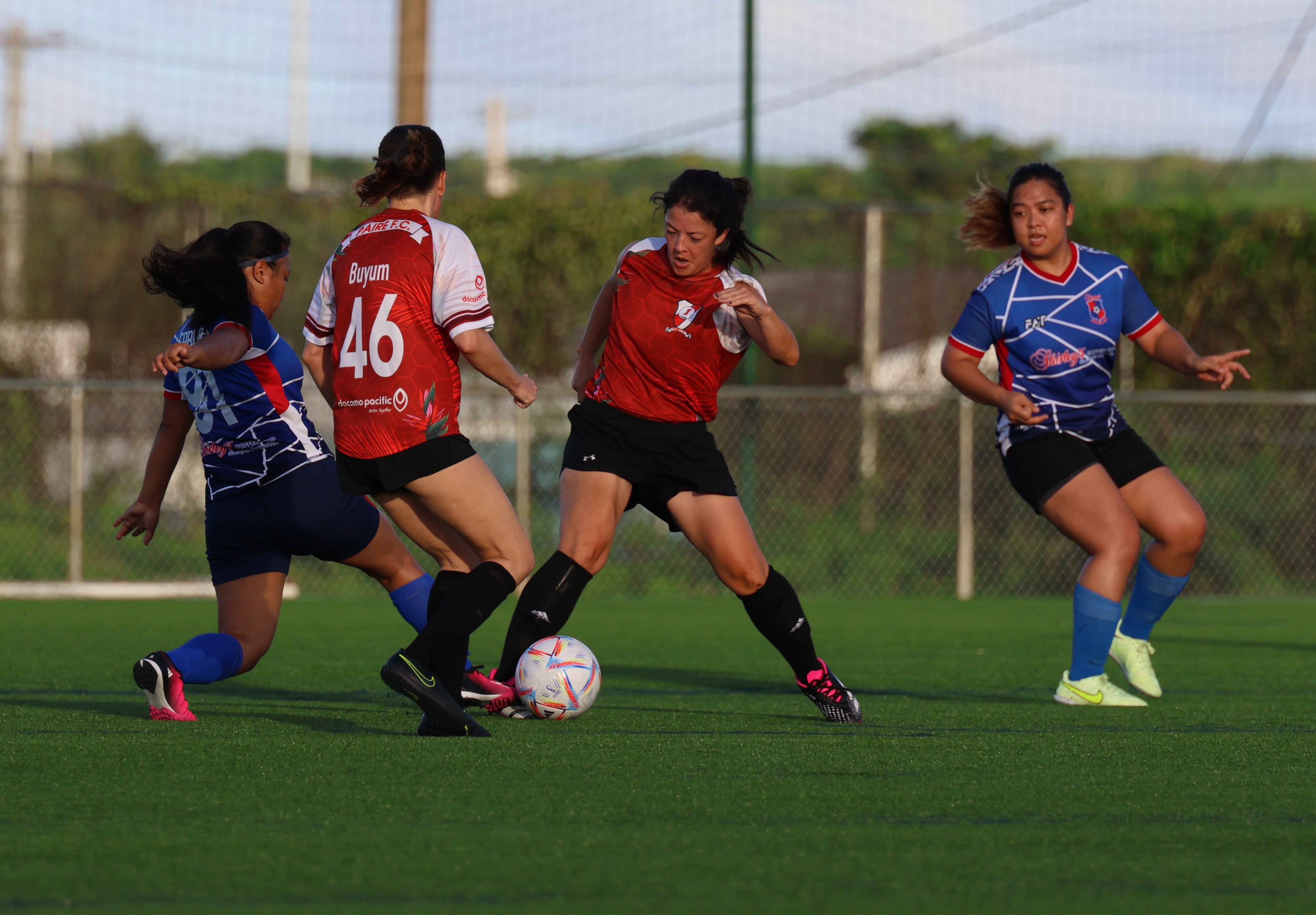A Paire Football Club 2 player reaches out to secure the possession against Shirley's Football Club in a  Flores-Pee Luwal (Intermediate) Division game of the 2023 Fall Dove Women’s League on Sunday at the NMI Soccer Training Center in Koblerville.