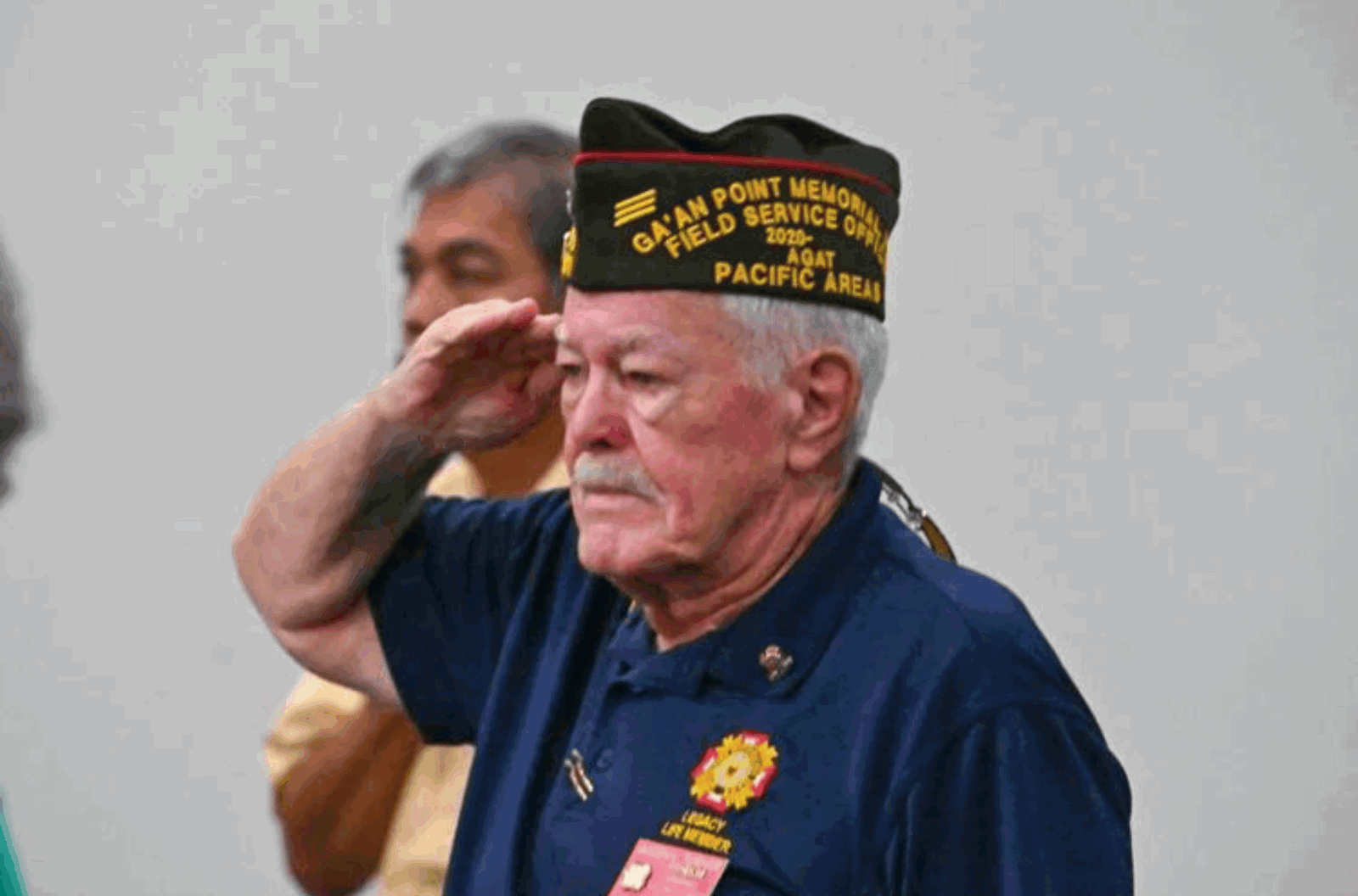 Veteran Allen L. Turner salutes during the national anthem at the start of the I Hinanao I Magahet Yan I Ininnahe, or HMI, Guam veterans benefits symposium, Tuesday Aug. 8, 2023, at the University of Guam CLASS Lecture Hall in Mangilao. 