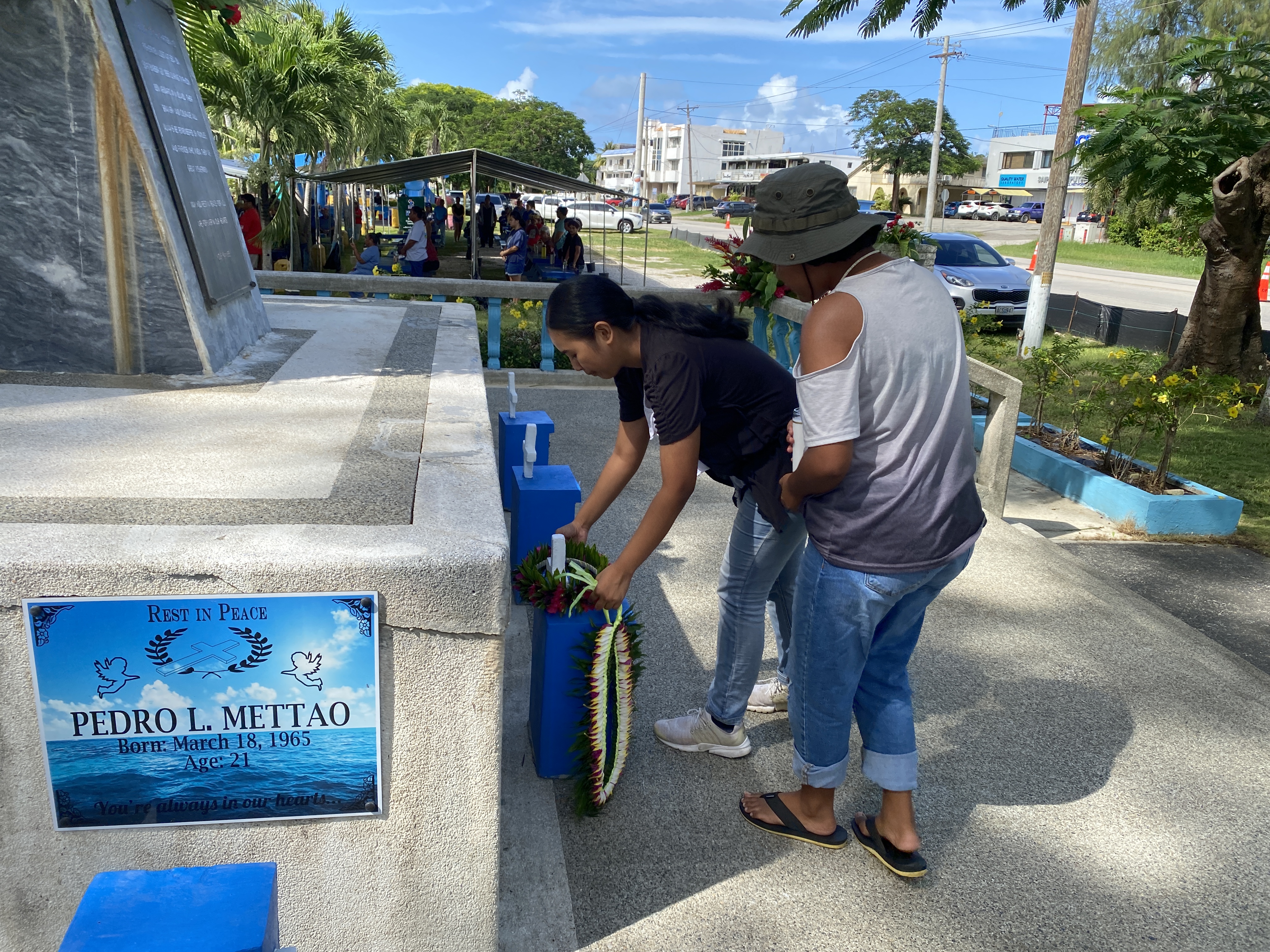 Family members lay a mwar and lei at the 13 Fishermen Memorial in Garapan on Beach Road on Saturday, Sept. 23.