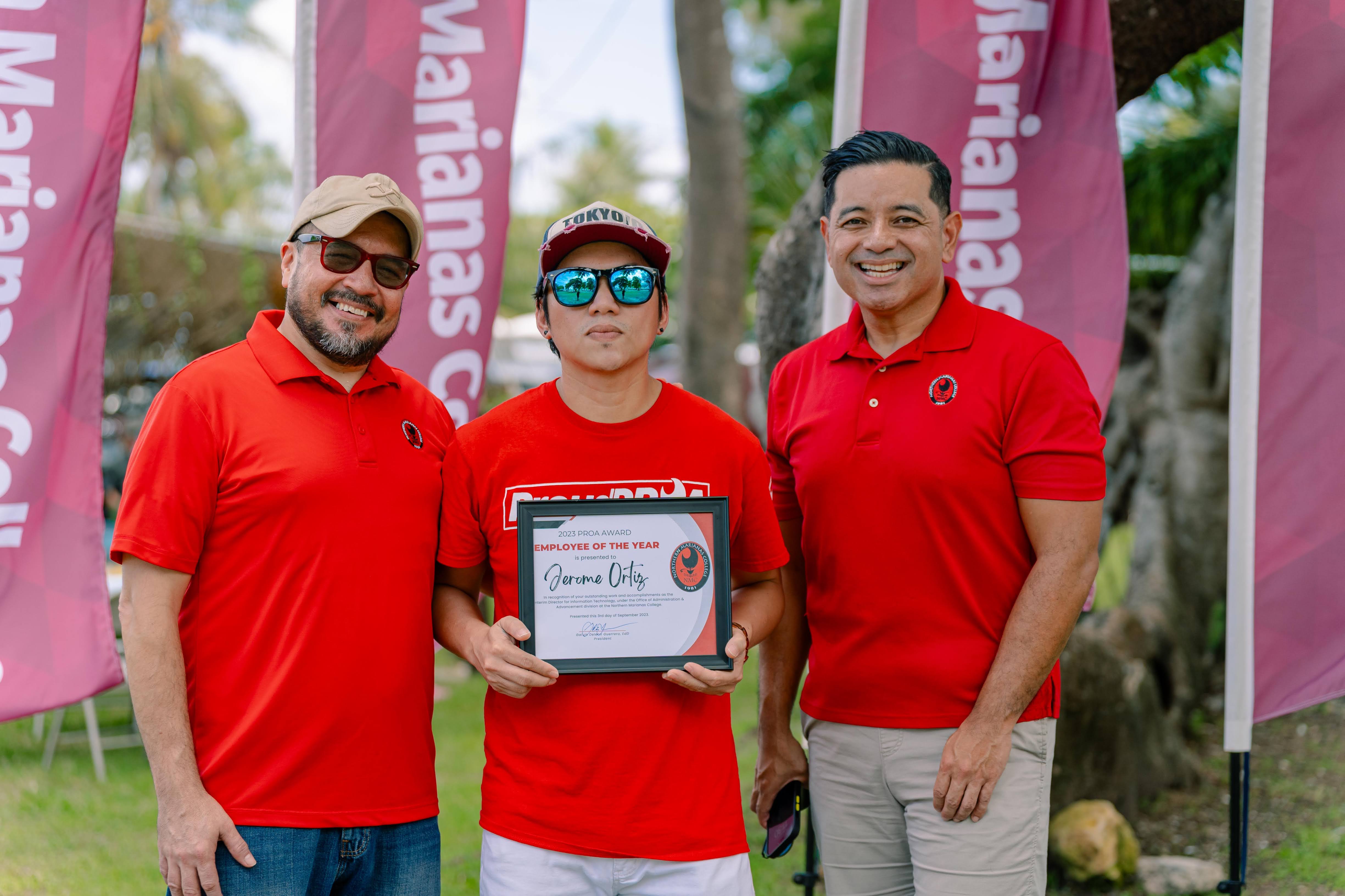Interim Information Technology Director and Employee of the Year Jerome Ortiz, center, with NMC President Galvin Deleon Guerrero, EdD, left, and NMC Vice President for Administration and Advancement Frankie Eliptico, right.