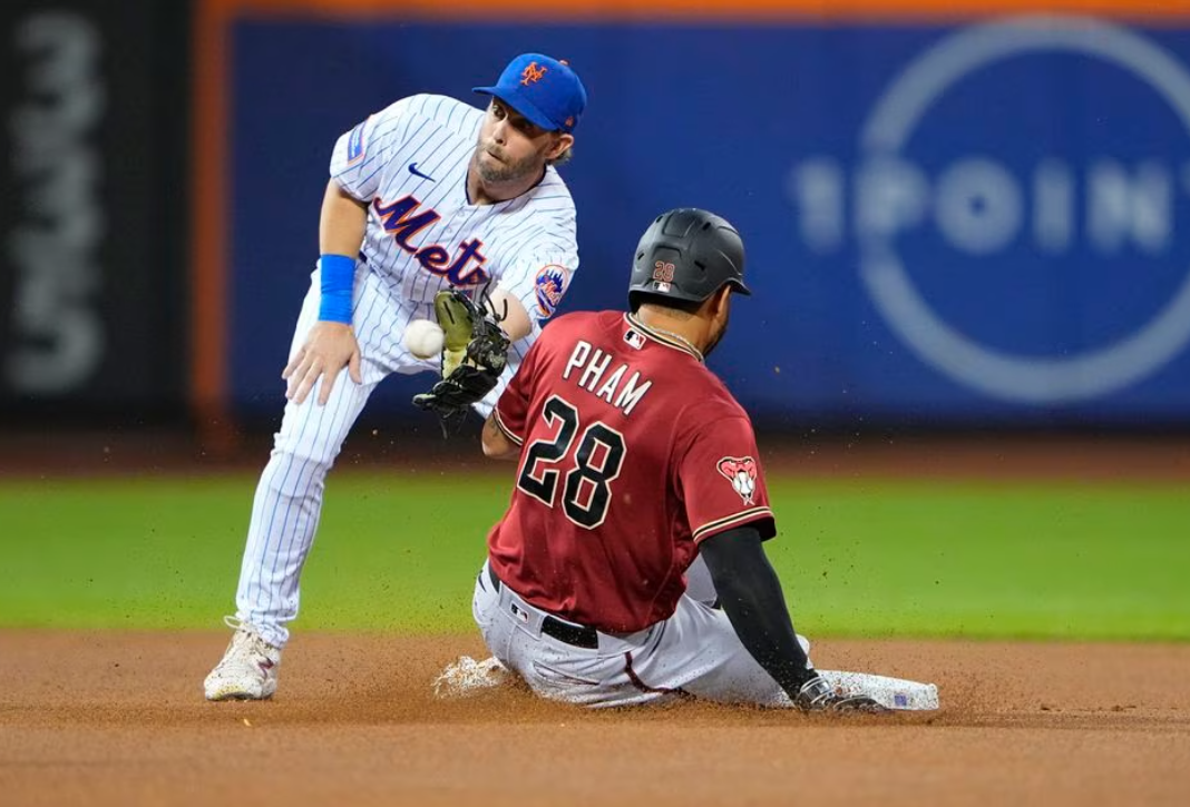 Arizona Diamondbacks right fielder Tommy Pham (28) steals second base ahead of the throw received by New York Mets second baseman Jeff McNeil (1) during the first inning at  Citi Field in New York City, Sept 13, 2023.