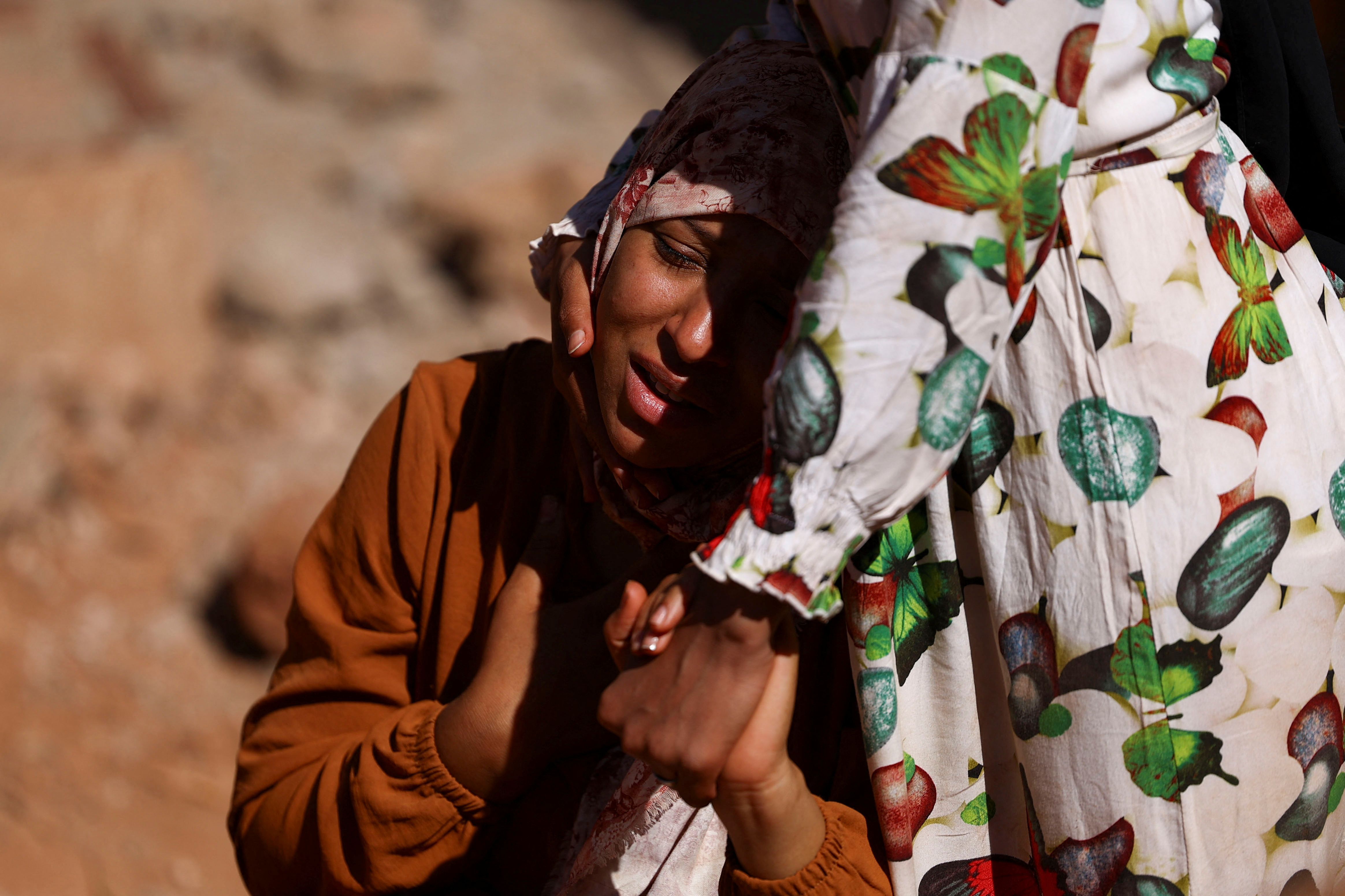 A relative reacts as rescue workers recover one body from the rubble, in the aftermath of a deadly earthquake in Ouirgane, Morocco, September 10, 2023. REUTERS/Hannah McKay