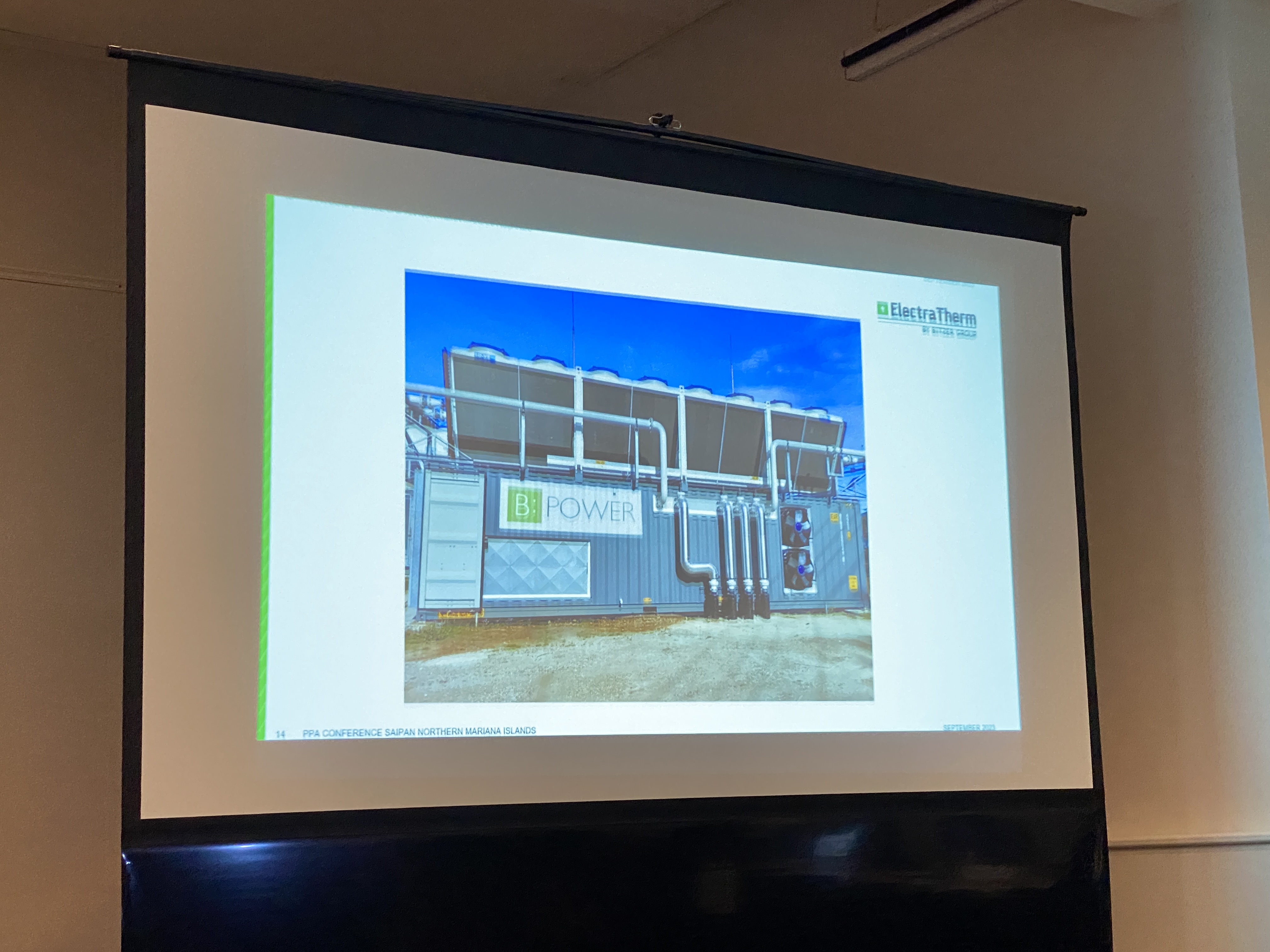 ElectraTherm Business Development Analyst David Knight — not in photo — explains the benefits of using shipping containers to house an Organic Rankine Cycle system as depicted in this image.