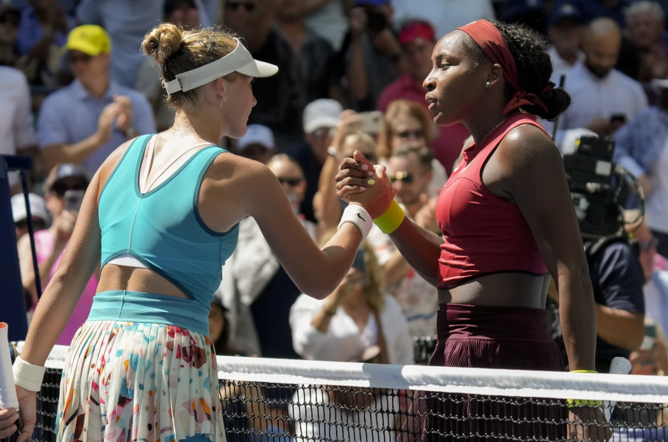 Coco Gauff of the U.S. shakes hands with Mirra Andreeva of Russia after winning their second round match of the U.S. Open tennis championships, Wednesday, Aug. 30, 2023, in New York.