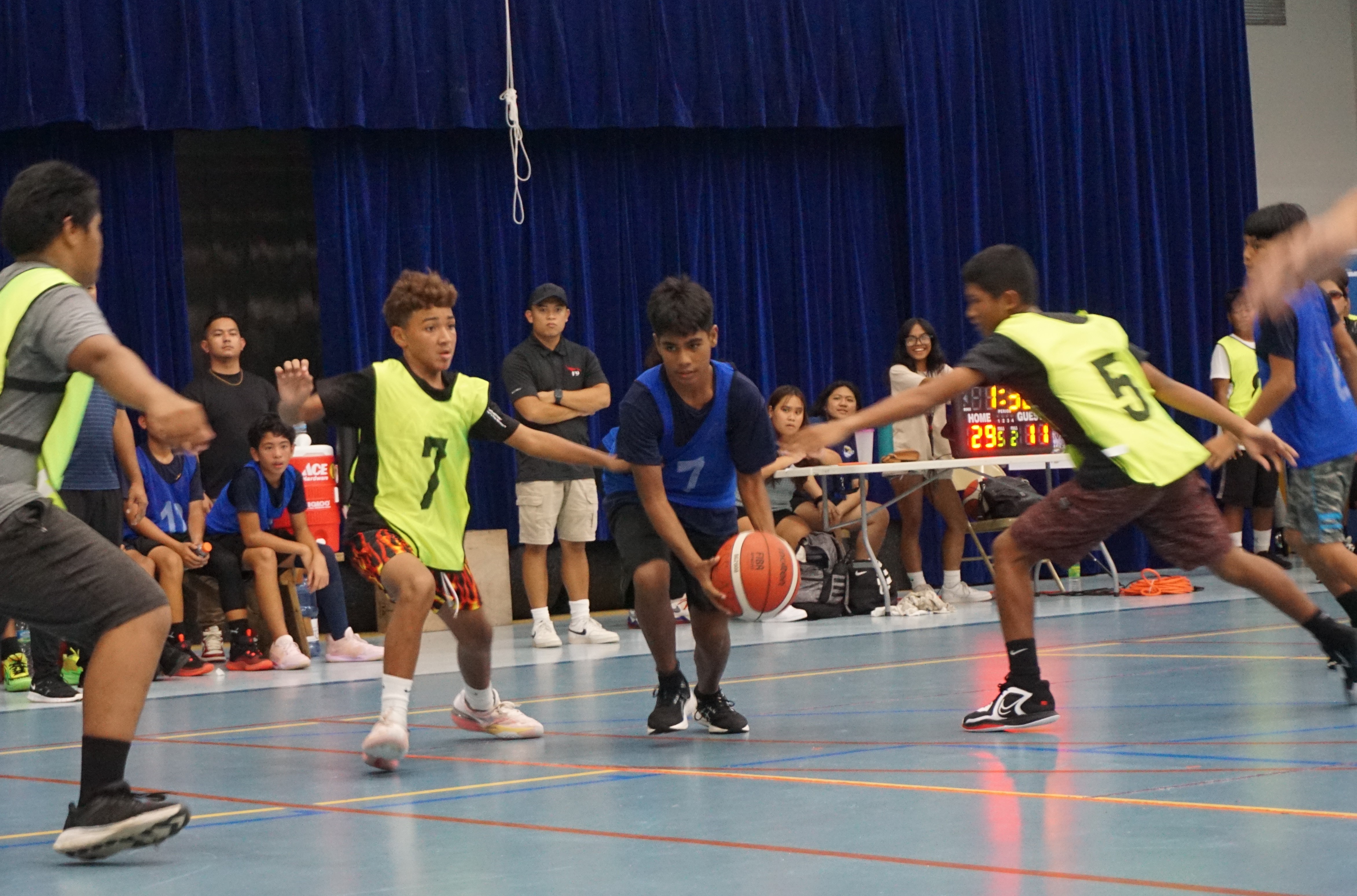 Hopwood Middle School's Jay Ruwayngeg protects the ball as he dribbles between two Chacha Ocean View Middle School defenders during a boys middle school division game of the IT&E-PSS Interscholastic Basketball League SY23-24 on Wednesday at the Marianas High School gym.