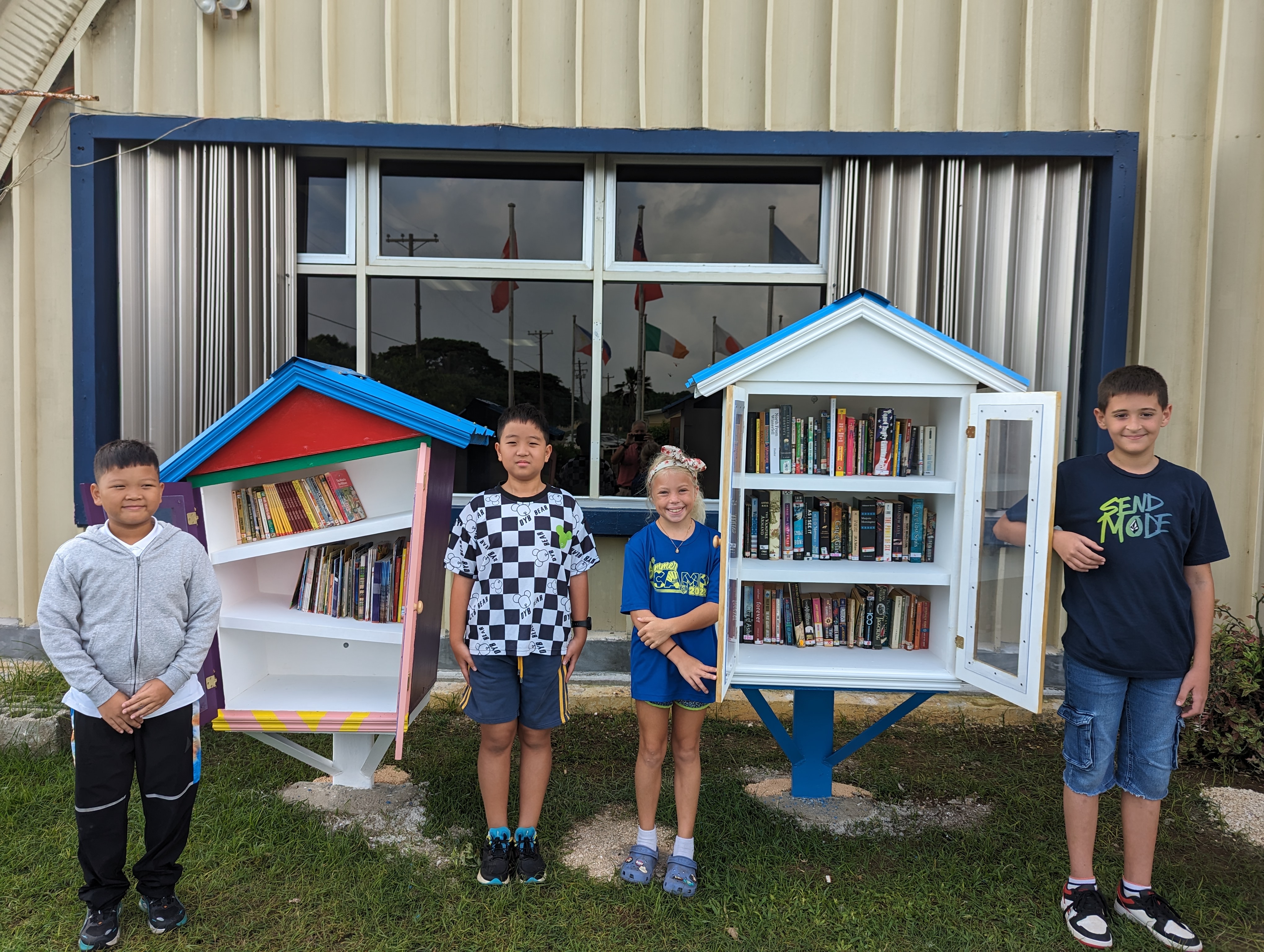 Grade 4 students pose in front of Little Library.