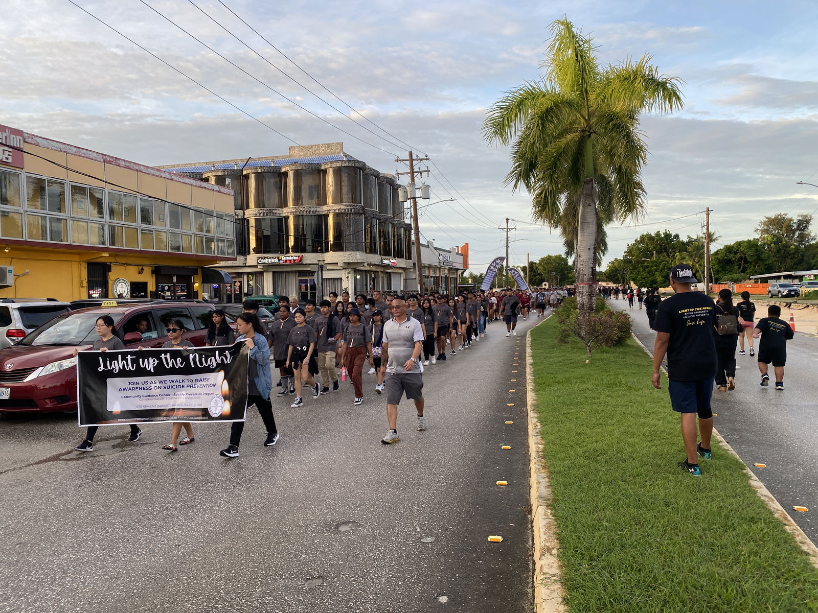 After turning at the Garapan fire station, JROTC cadets and mental health stakeholders march south through Garapan.